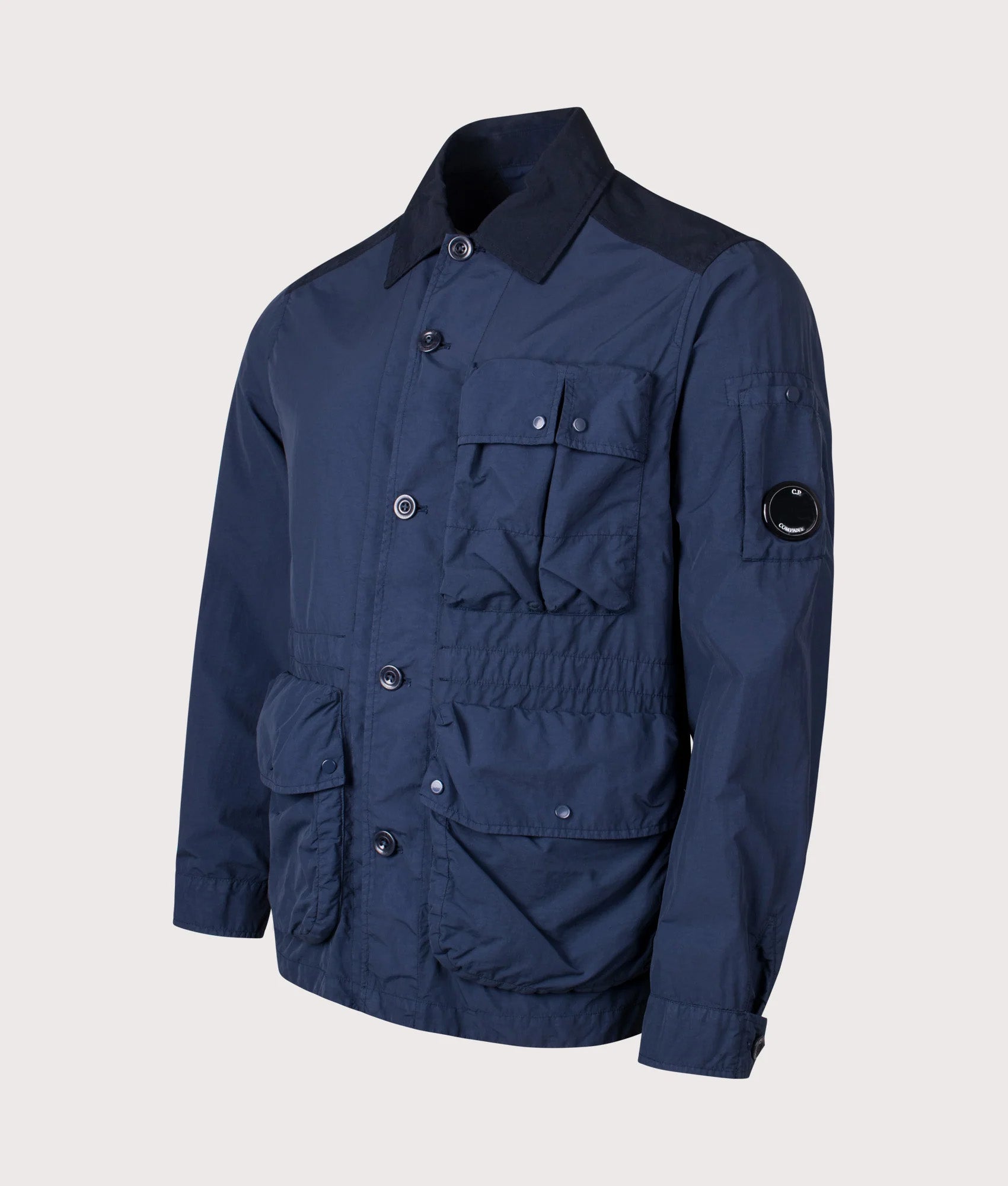 C.P. Company Flatt Nylon Mixed Button Lens Jacket in Midnight Navy at EQVVS Menswear. Angled front shot.