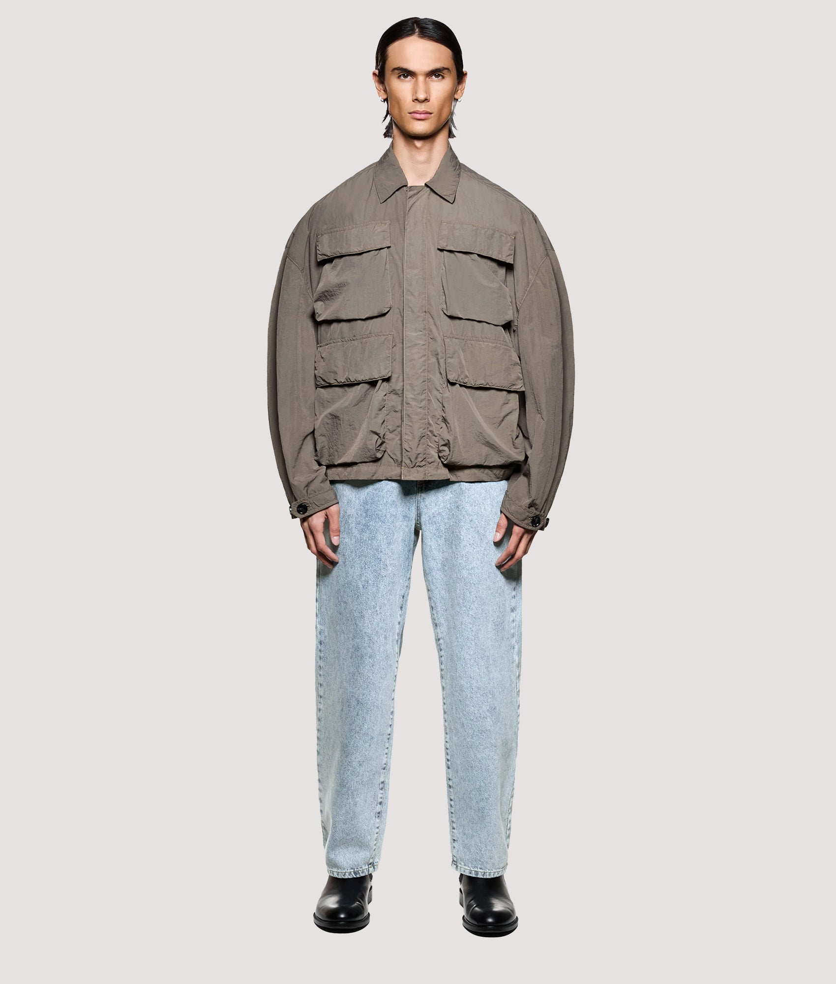 MKI MIYUKI ZOKU Box Fit Garment Dye Overshirt in Deep Khaki at EQVVS Menswear. Model full front shot.