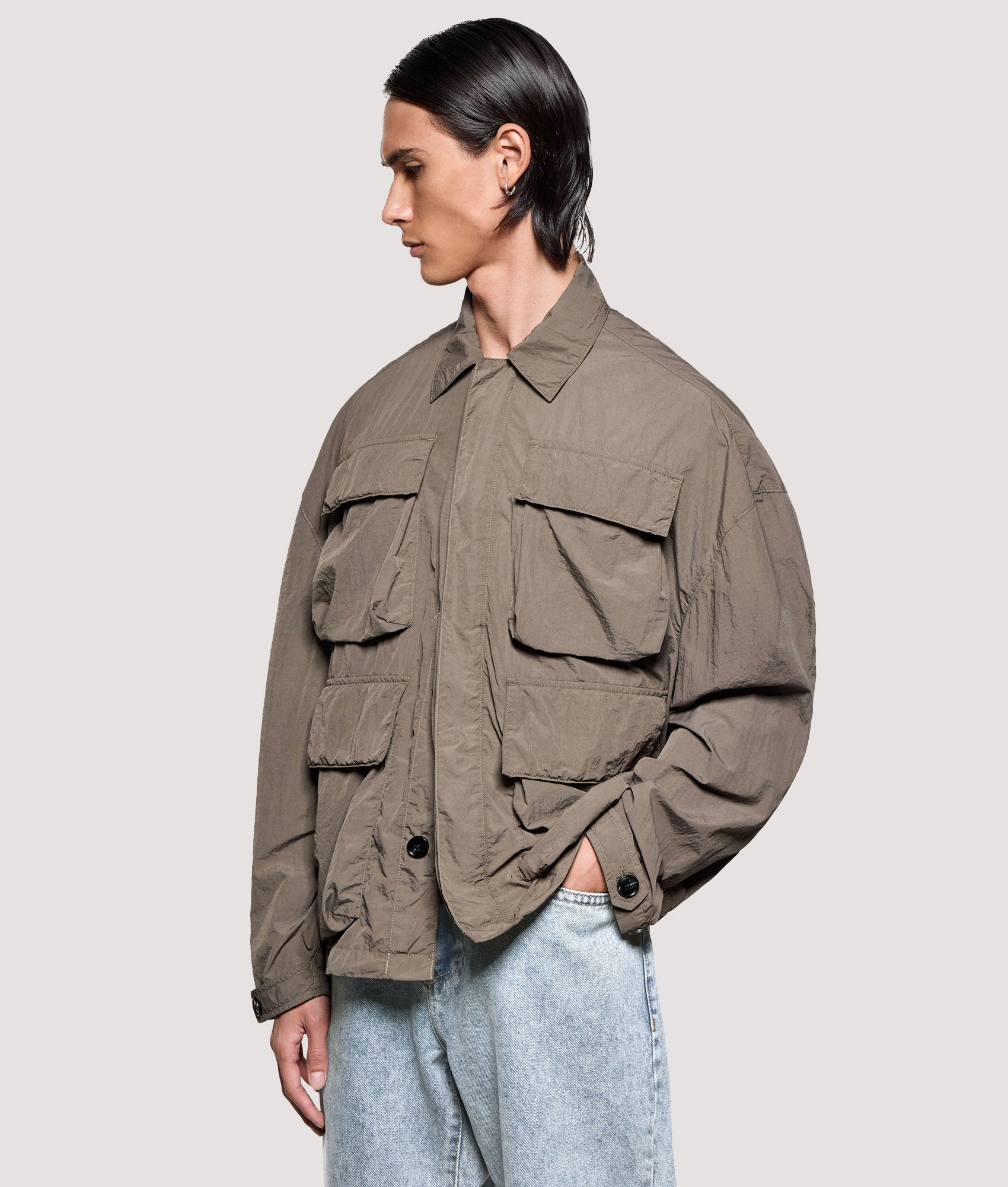 MKI MIYUKI ZOKU Box Fit Garment Dye Overshirt in Deep Khaki at EQVVS Menswear. Angled model front shot.