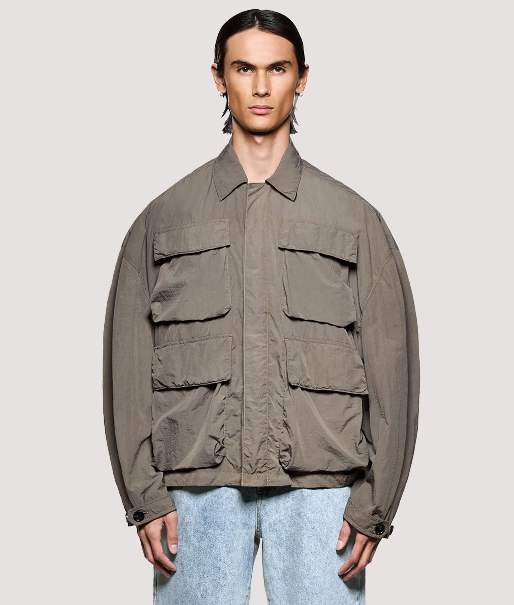 MKI MIYUKI ZOKU Box Fit Garment Dye Overshirt in Deep Khaki at EQVVS Menswear. Model front shot.