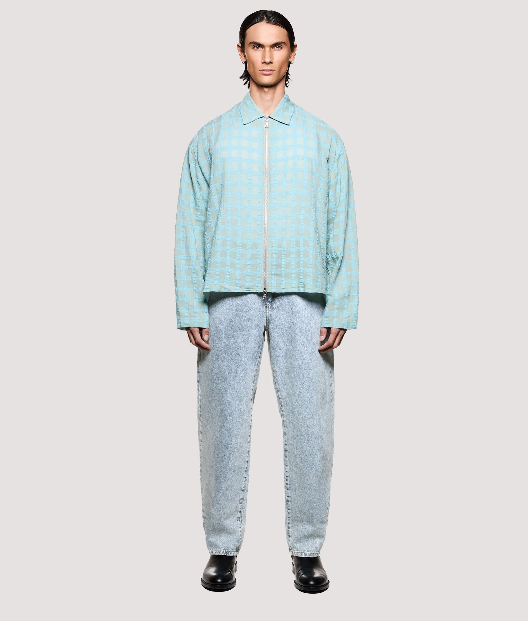 MKI MIYUKI ZOKU Box Fit Grid Check Rider in Sage at EQVVS Menswear. Model full front shot.