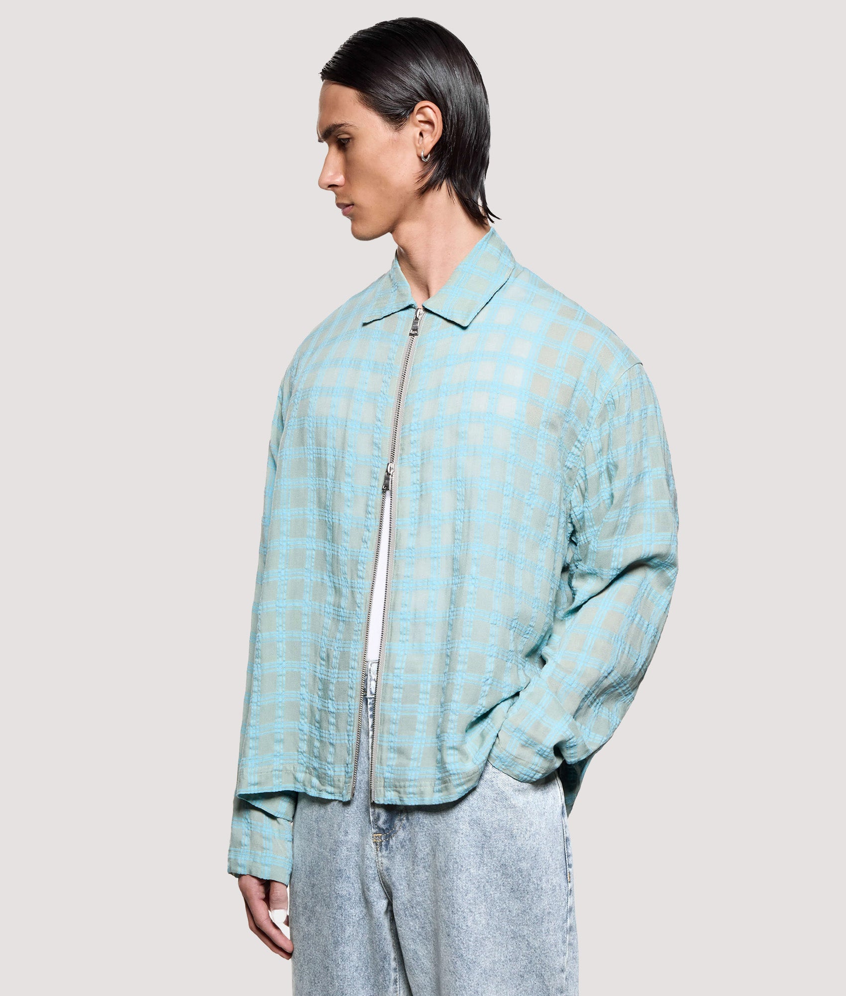 MKI MIYUKI ZOKU Box Fit Grid Check Rider in Sage at EQVVS Menswear. Angled model front shot.