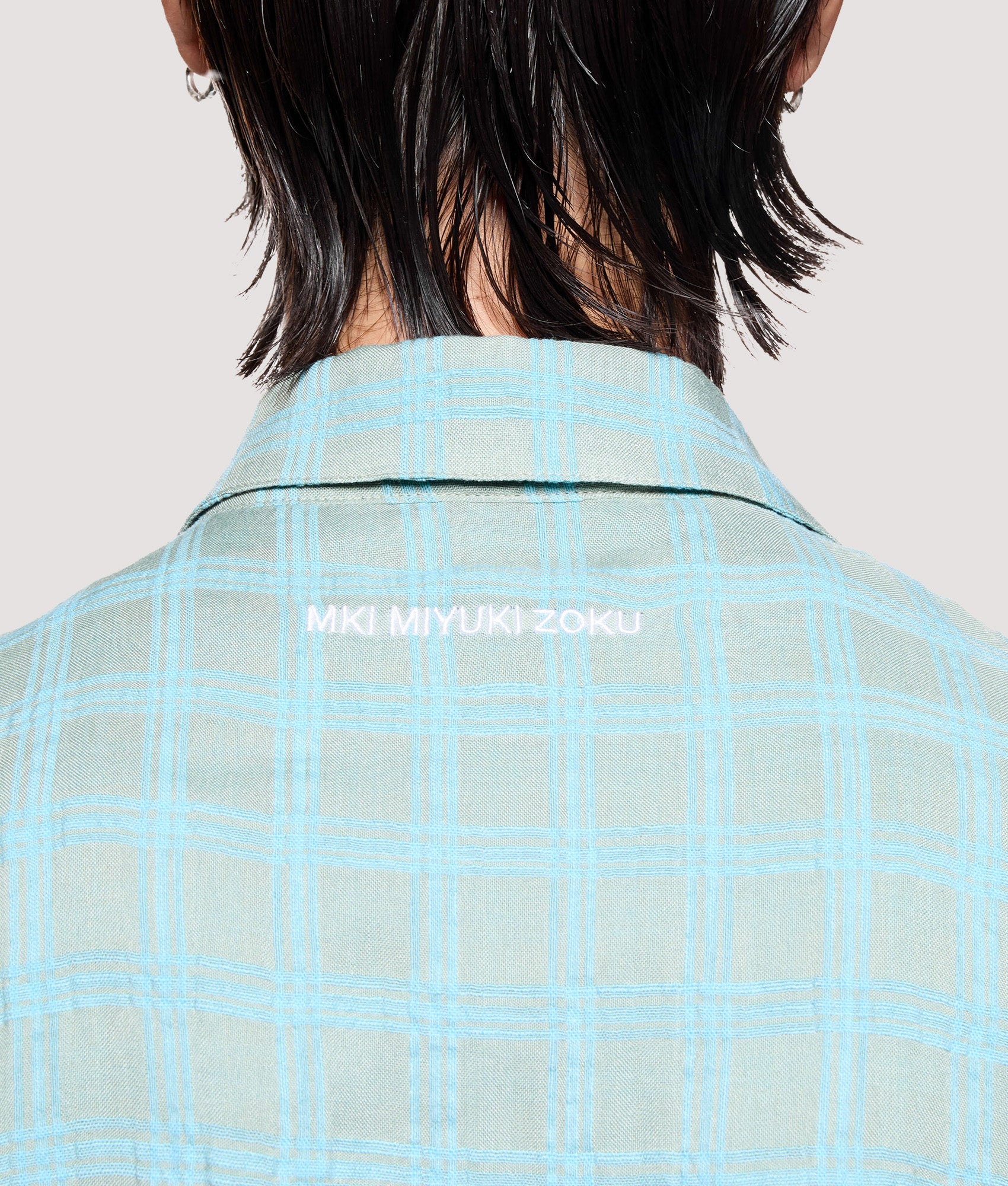 MKI MIYUKI ZOKU Box Fit Grid Check Rider in Sage at EQVVS Menswear. Back detail shot.