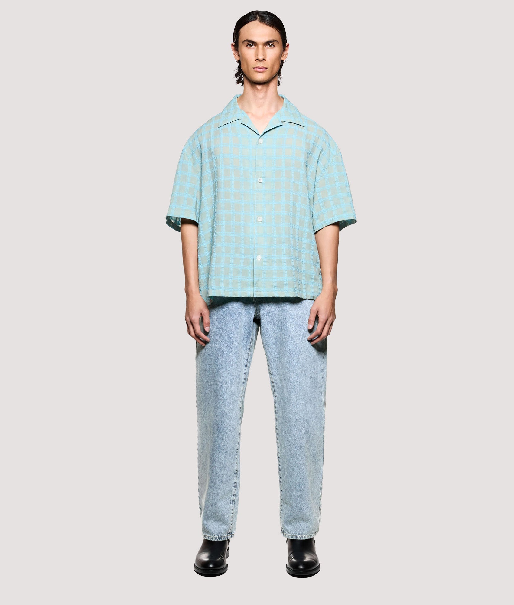 MKI MIYUKI ZOKU Box Fit Grid Check Short Sleeve Vacation Shirt in sage at EQVVS Menswear. Model full front shot.