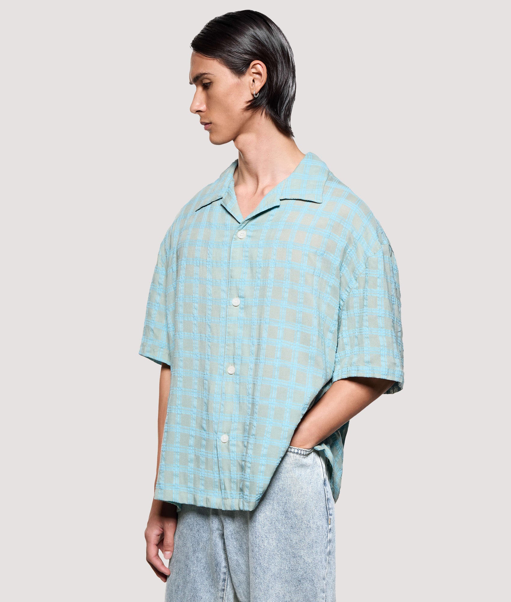 MKI MIYUKI ZOKU Box Fit Grid Check Short Sleeve Vacation Shirt in sage at EQVVS Menswear. Angled model front shot.