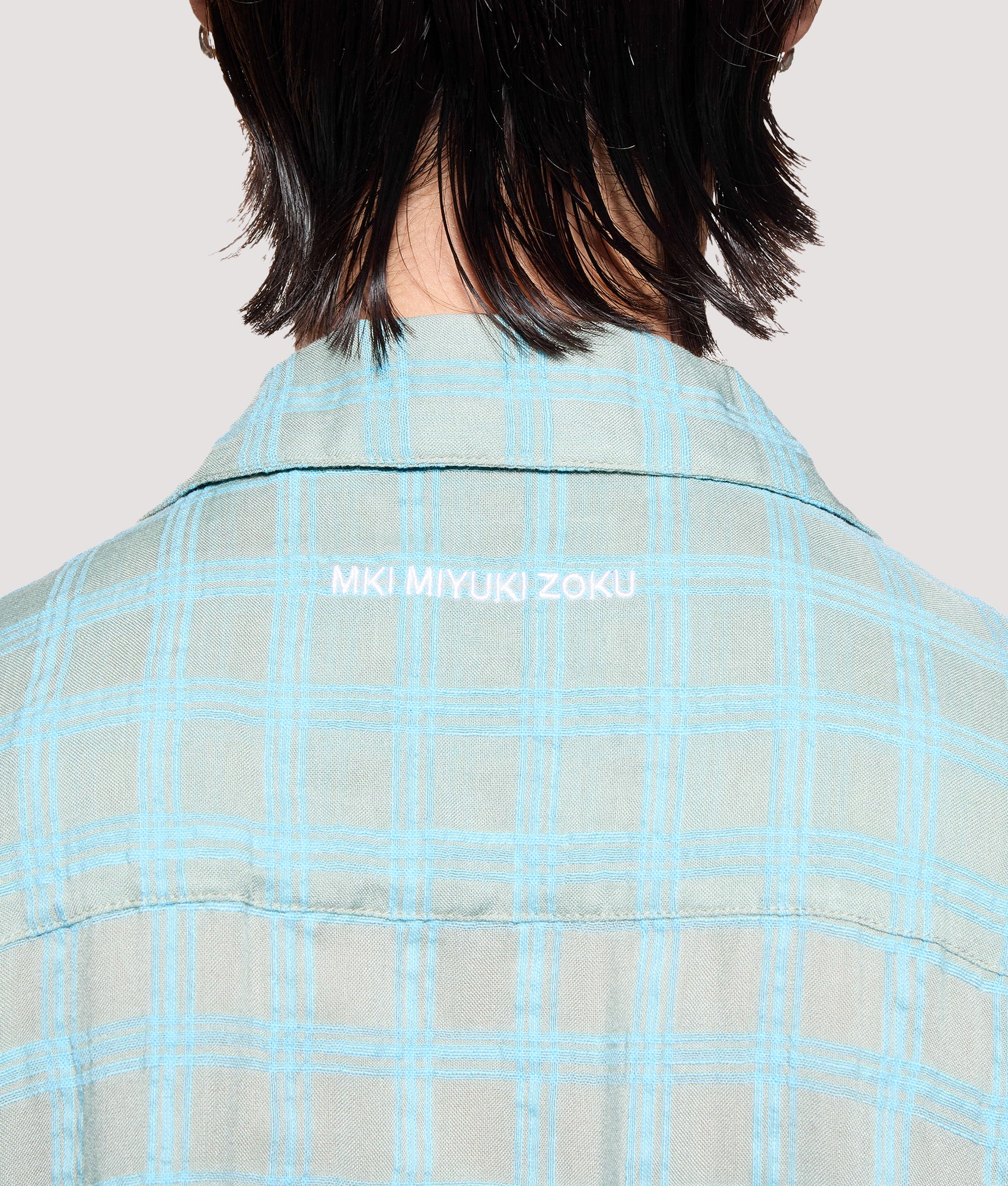 MKI MIYUKI ZOKU Box Fit Grid Check Short Sleeve Vacation Shirt in sage at EQVVS Menswear. Back detail shot.