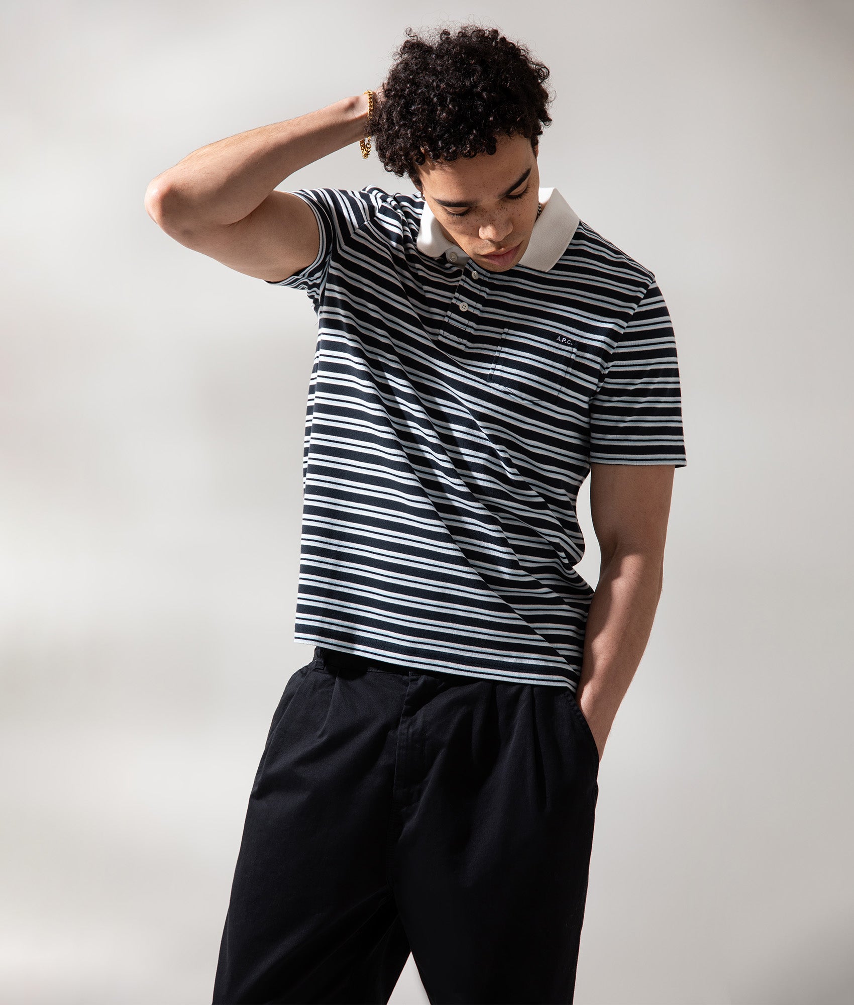 A.P.C. Relaxed fit Oscar Striped Polo Shirt in Dark Navy at EQVVS Menswear. Campaign Shot