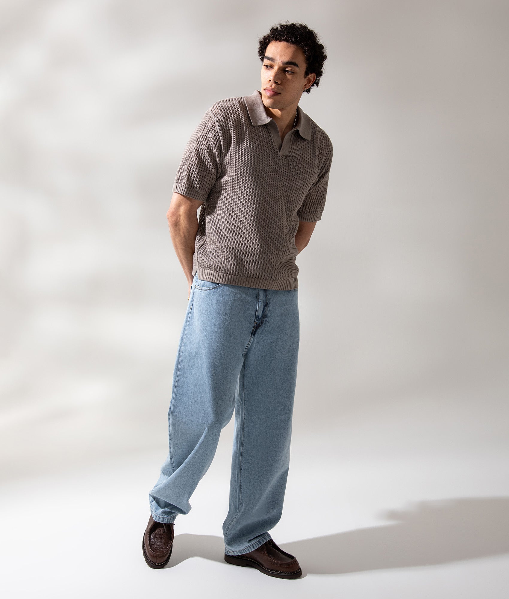REPRESENT Beverly Open Gauge Knitted Polo Shirt in Vintage Khaki at EQVVS Menswear. Campaign shot.