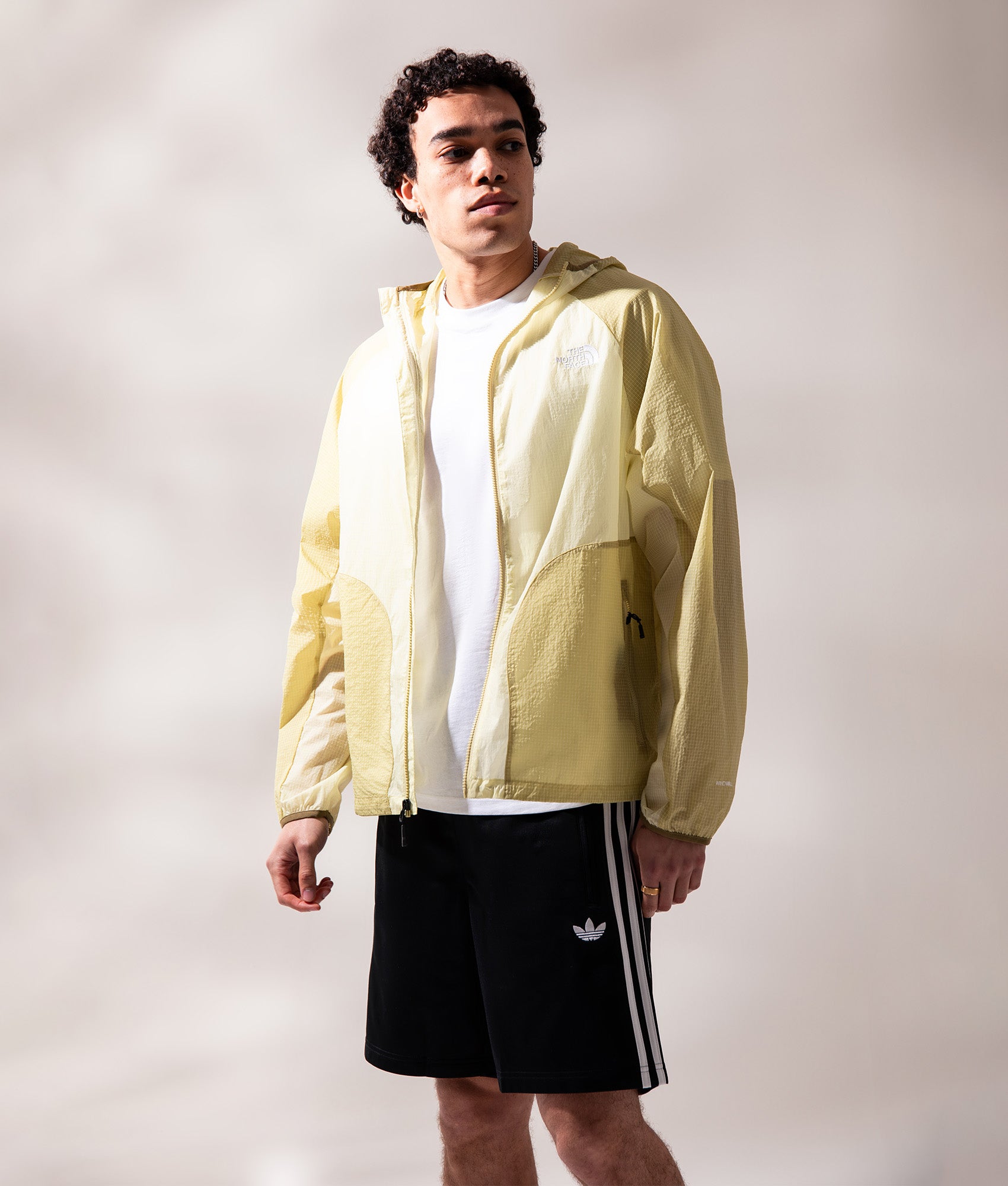 The North Face NSE Windbreaker in Lemon Mist at EQVVS Menswear. Campaign shot.