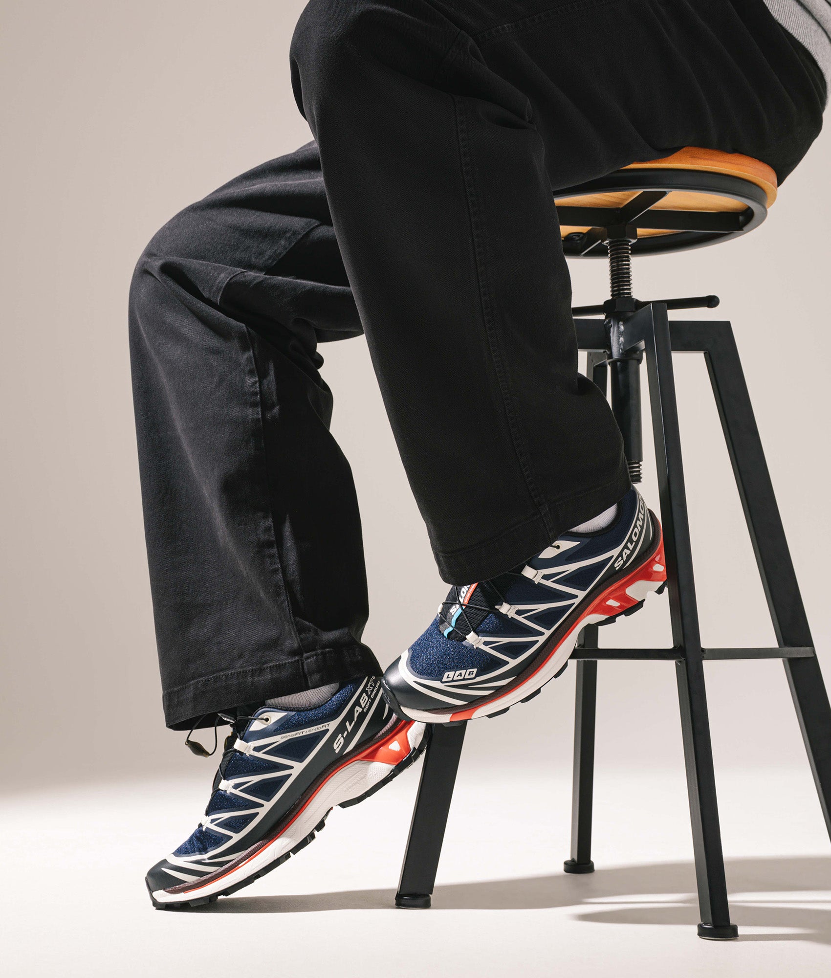 SALOMON XT-6 in Blue, Black and Fiery Red at EQVVS Menswear. On foot shot.