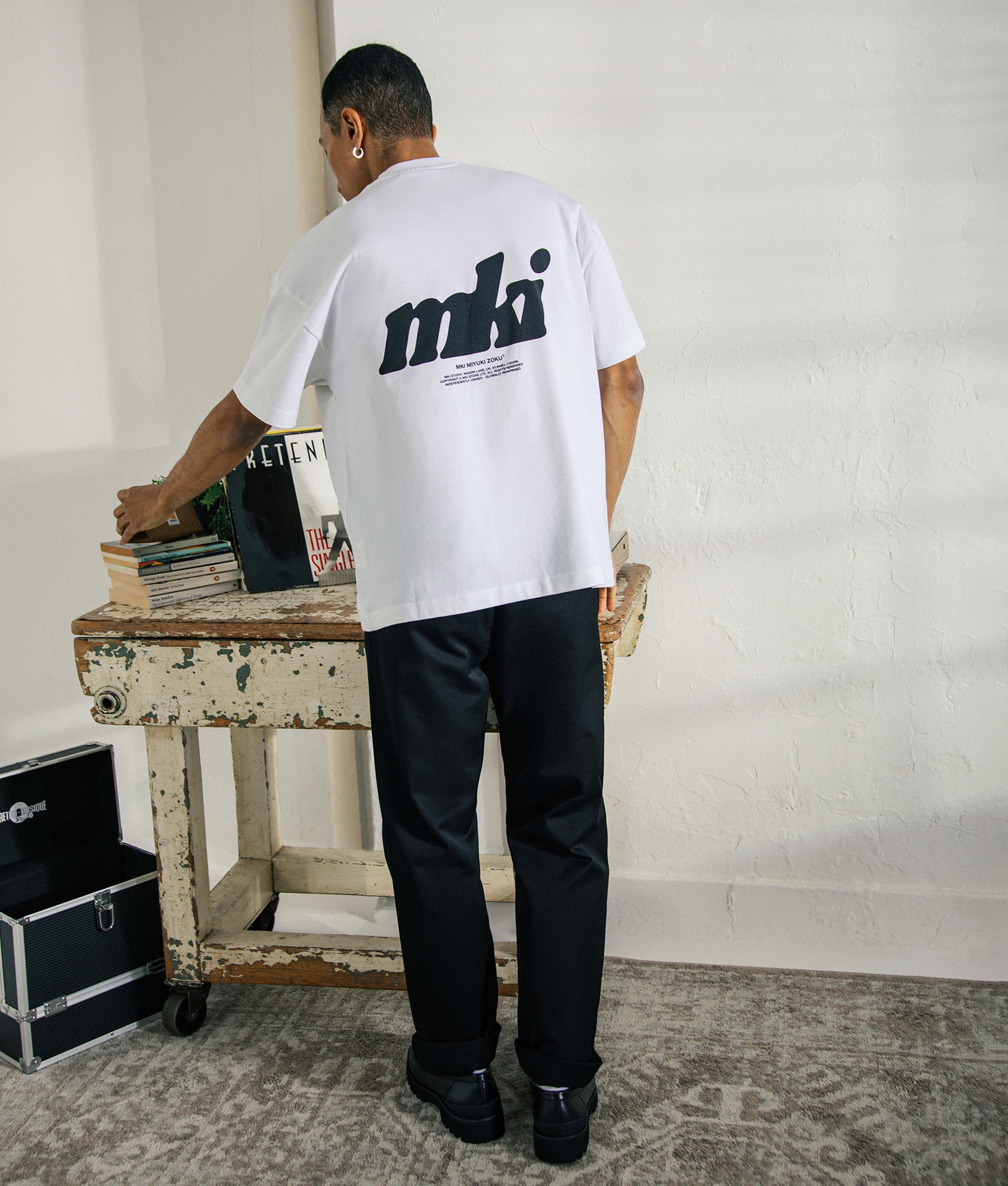 MKI MIYUKI ZOKU Stamp T-Shirt in white at EQVVS Menswear. Campaign shot.