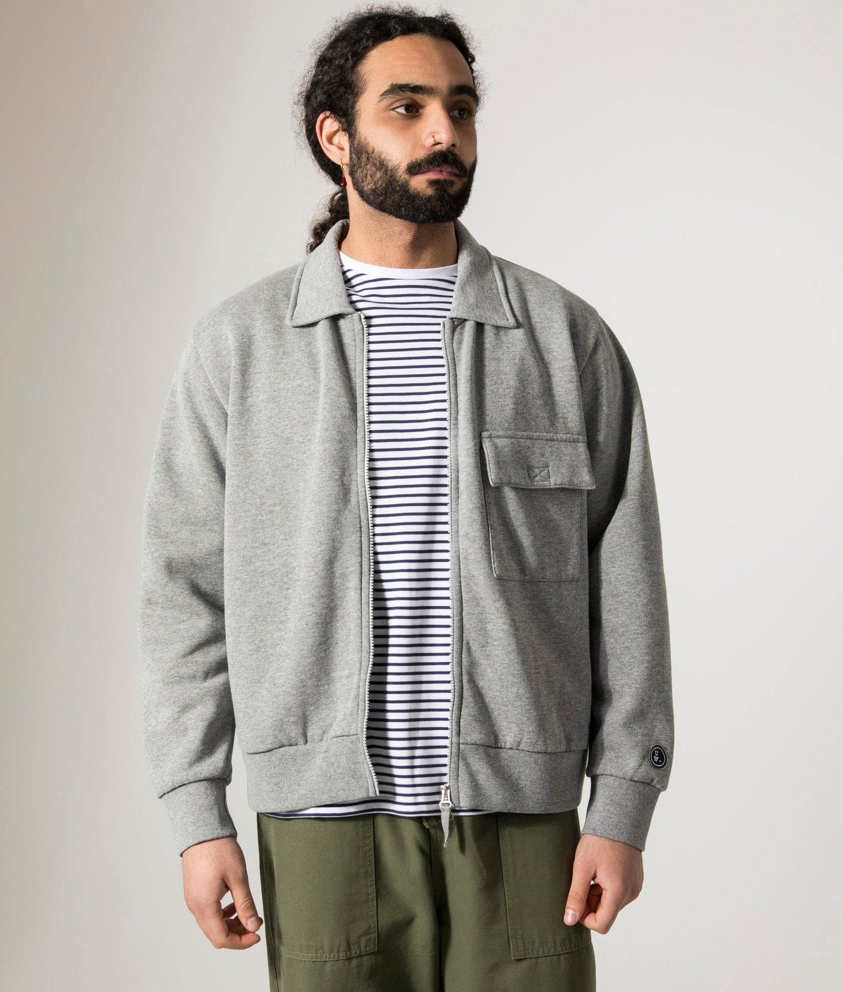 Universal Works Tyler Jacket in Grey Marl. Shot at EQVVS.  Model back shot. 