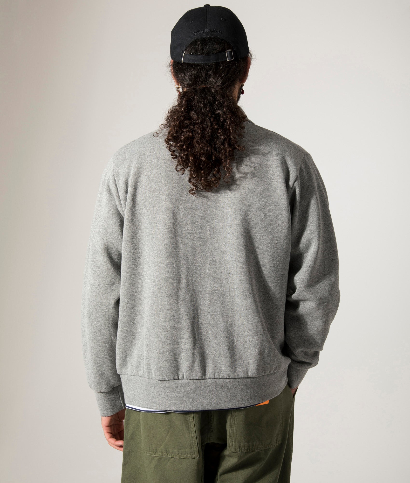 Universal Works Tyler Jacket in Grey Marl. Shot at EQVVS.  Model back shot. 