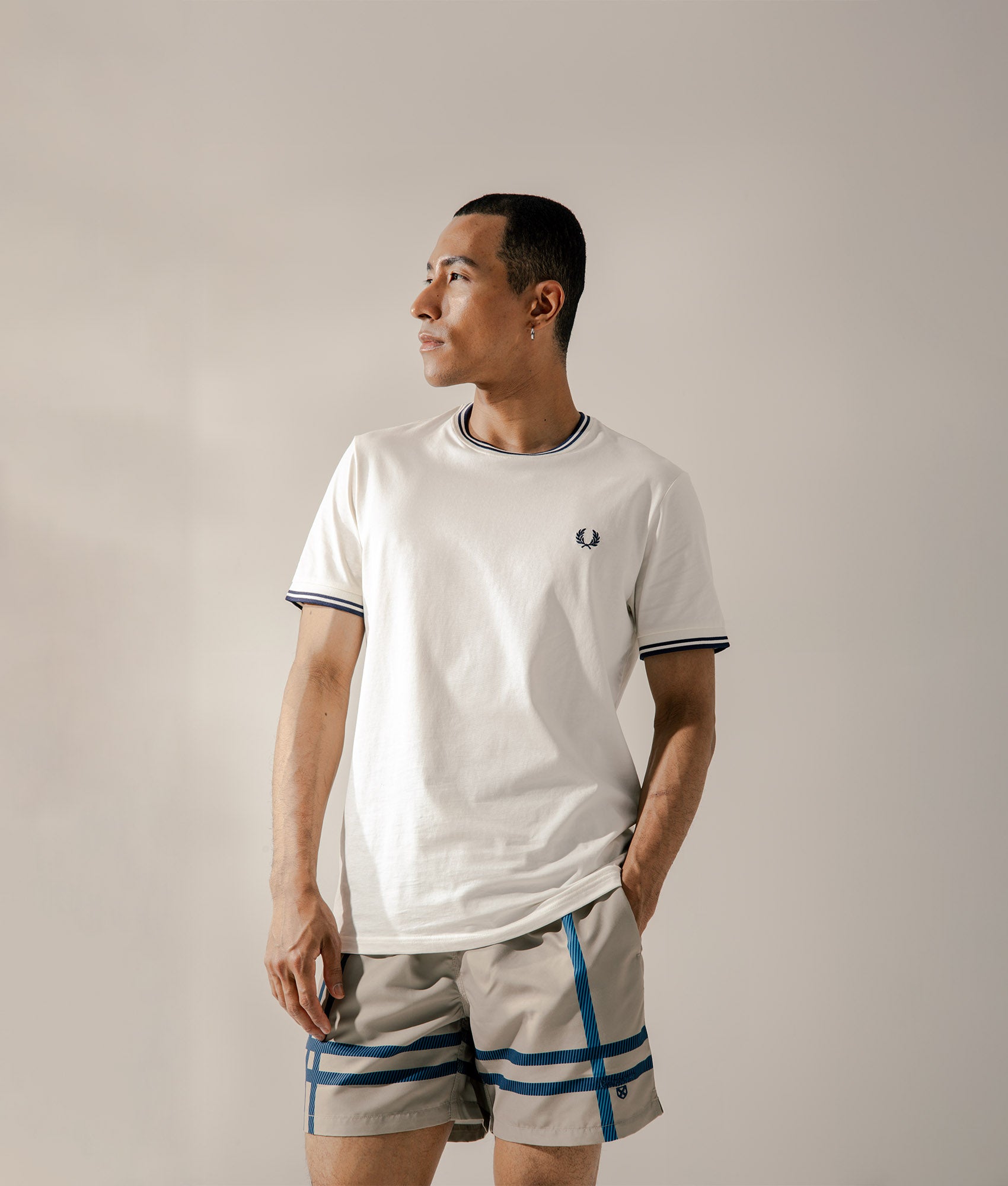 Fred Perry Twin Tipped T-Shirt in White at EQVVS Menswear. Campaign shot.