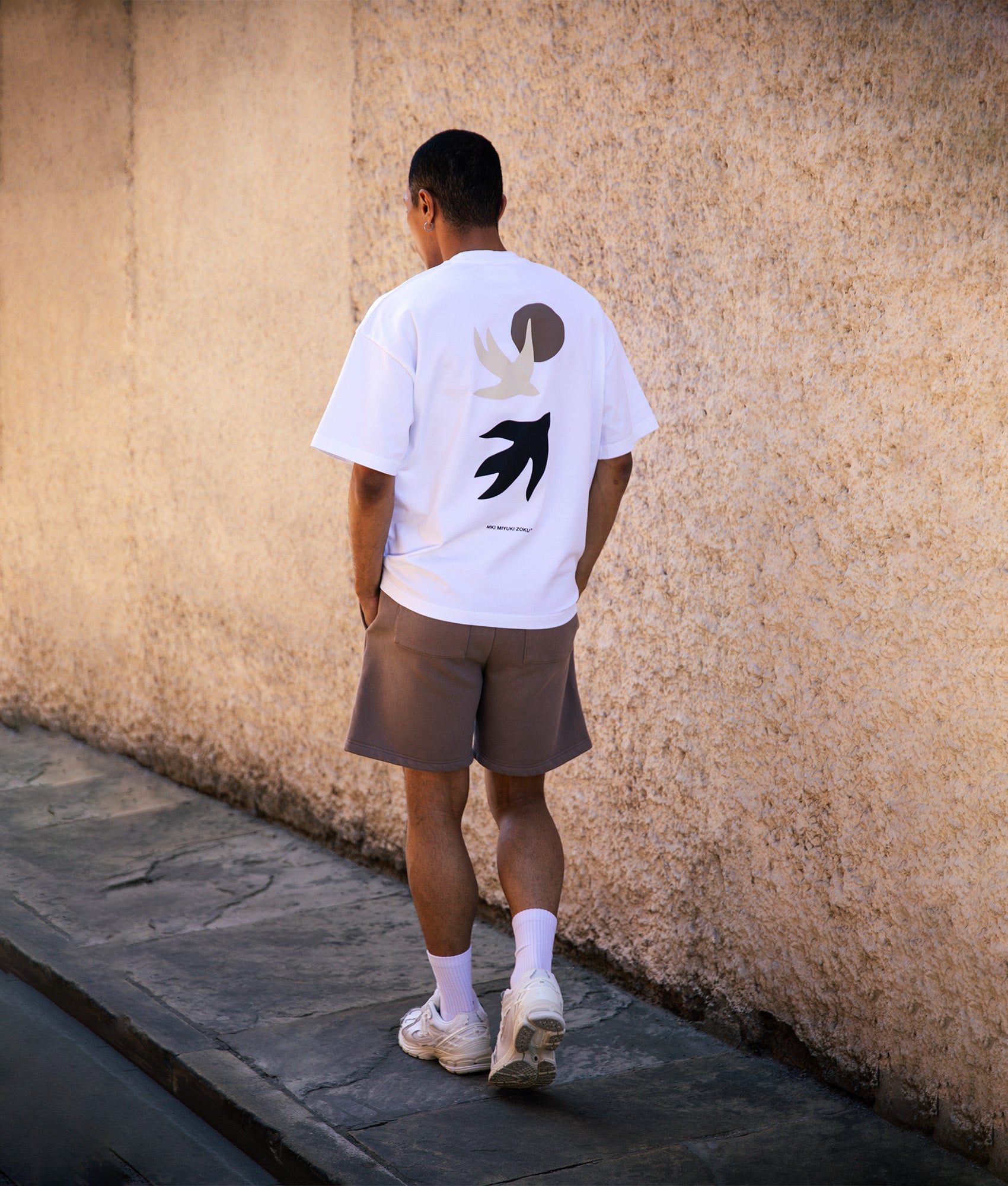 MKI MIYUKI ZOKU Oversized Swallow T-Shirt in White at EQVVS Menswear. Campaign shot.
