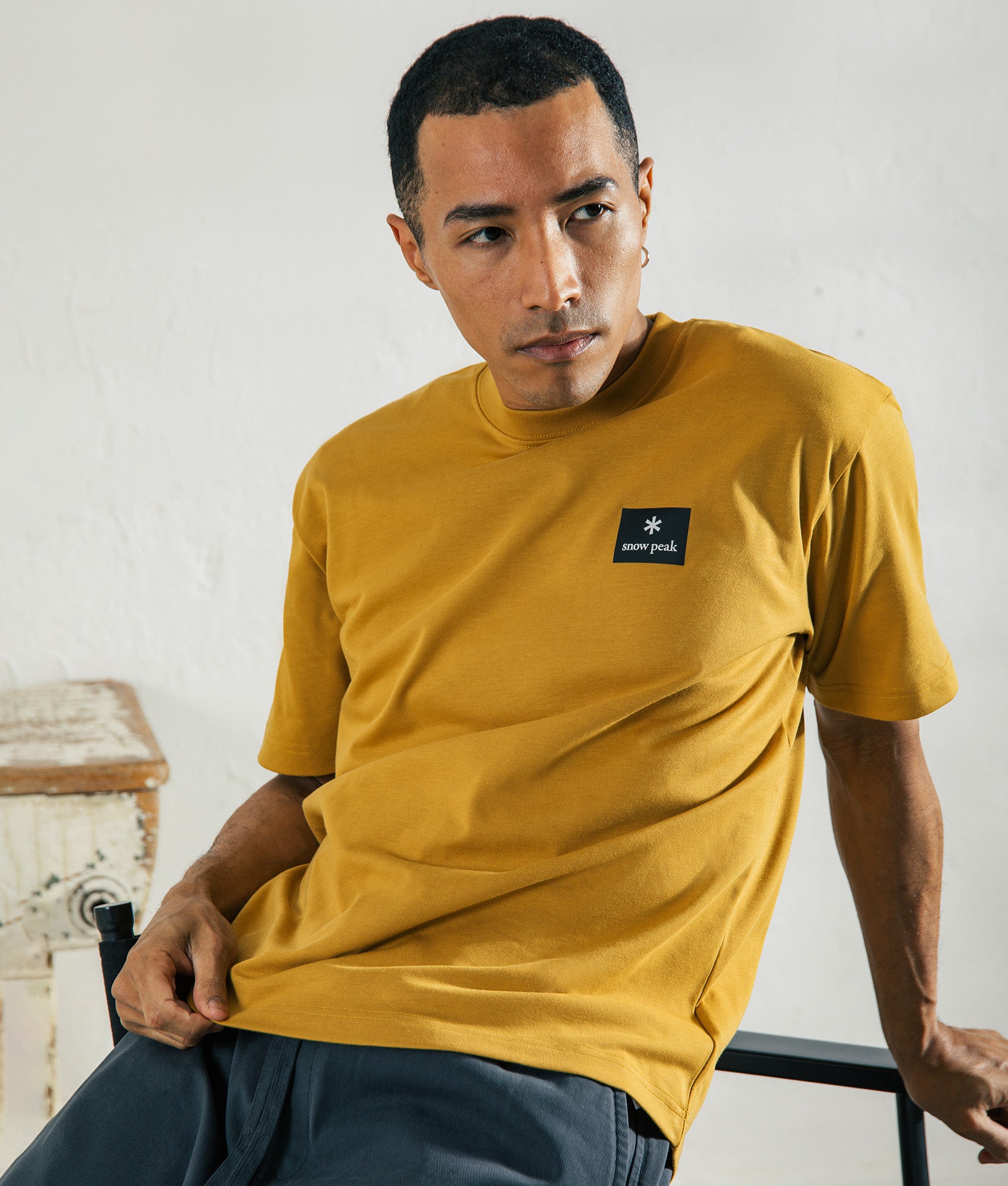 Snow Peak New Standard Square Logo T-Shirt in Yellow at EQVVS Menswear. Campaign shot