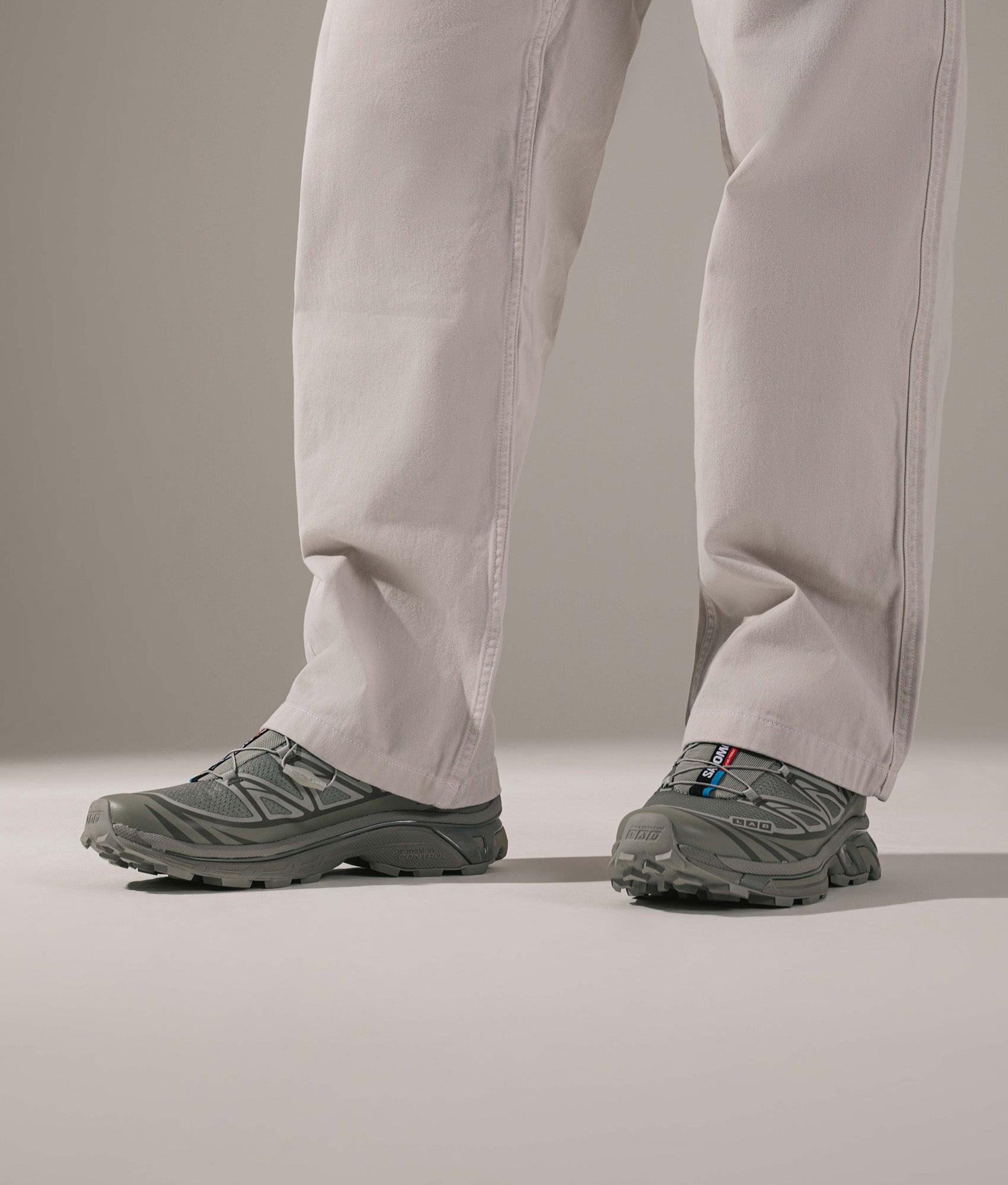 SALOMON XT-6 in Ghost Gray and Gray Flannel at EQVVS Menswear. On foot shot.