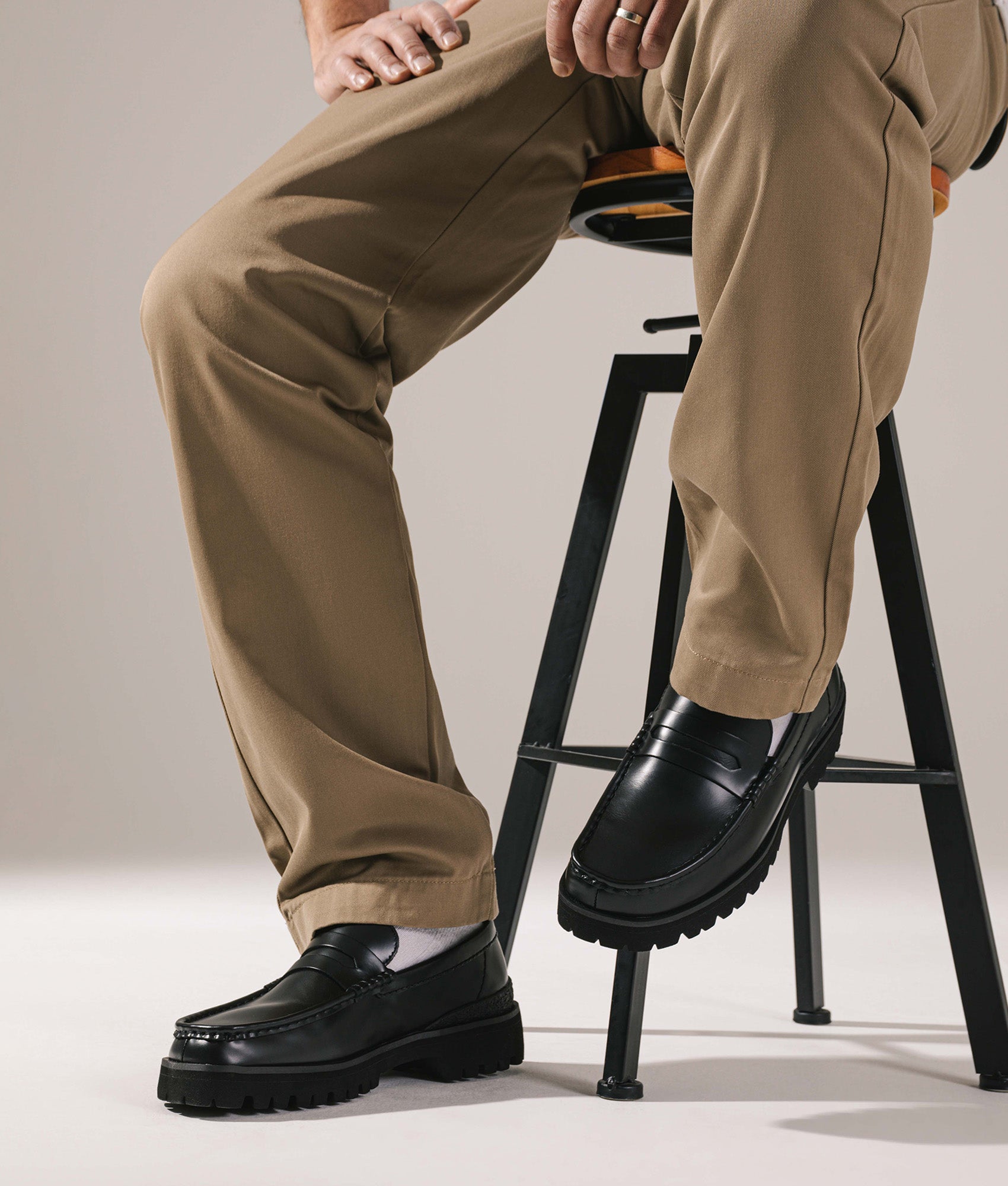 Clarks Originals Yukoner Penny Loafers in Black Leather at EQVVS Menswear. On foot shot.