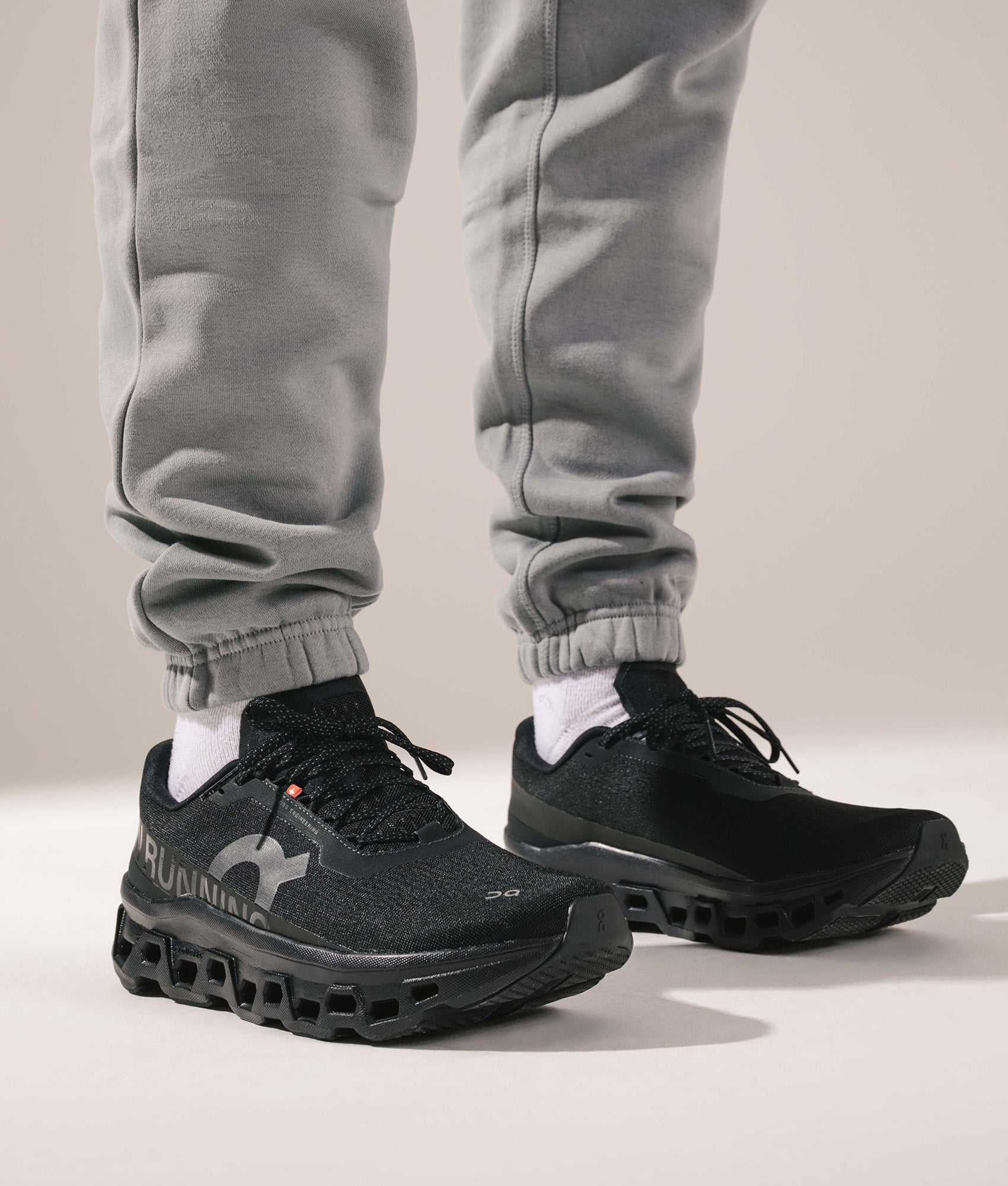 On Cloudmonster 1 Sneakers in Black/Black at EQVVS Menswear. On foot shot.
