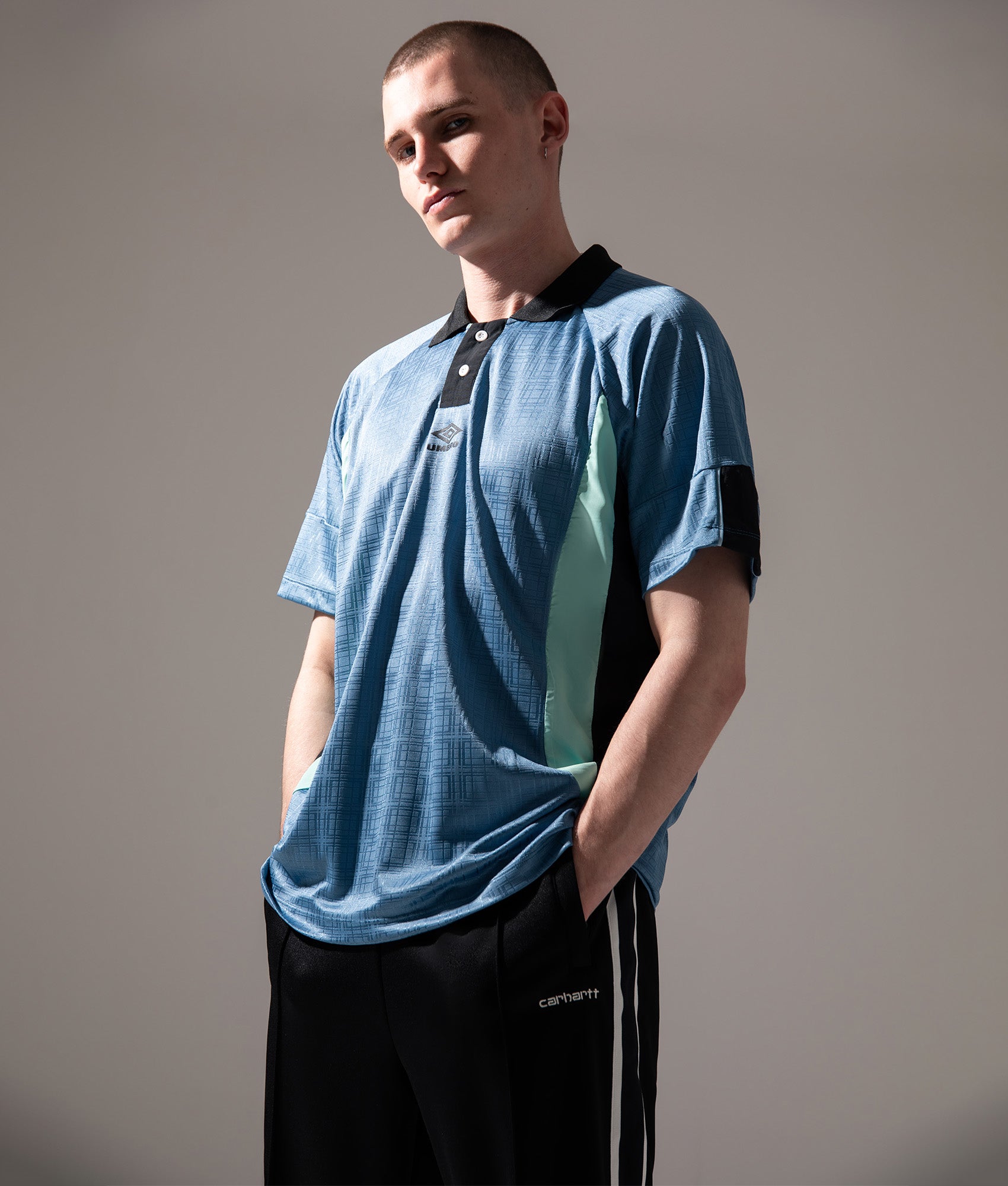 Umbro Football Shirt in Infinity, Black and Ocean Wave at EQVVS Menswear. Campaign shot.