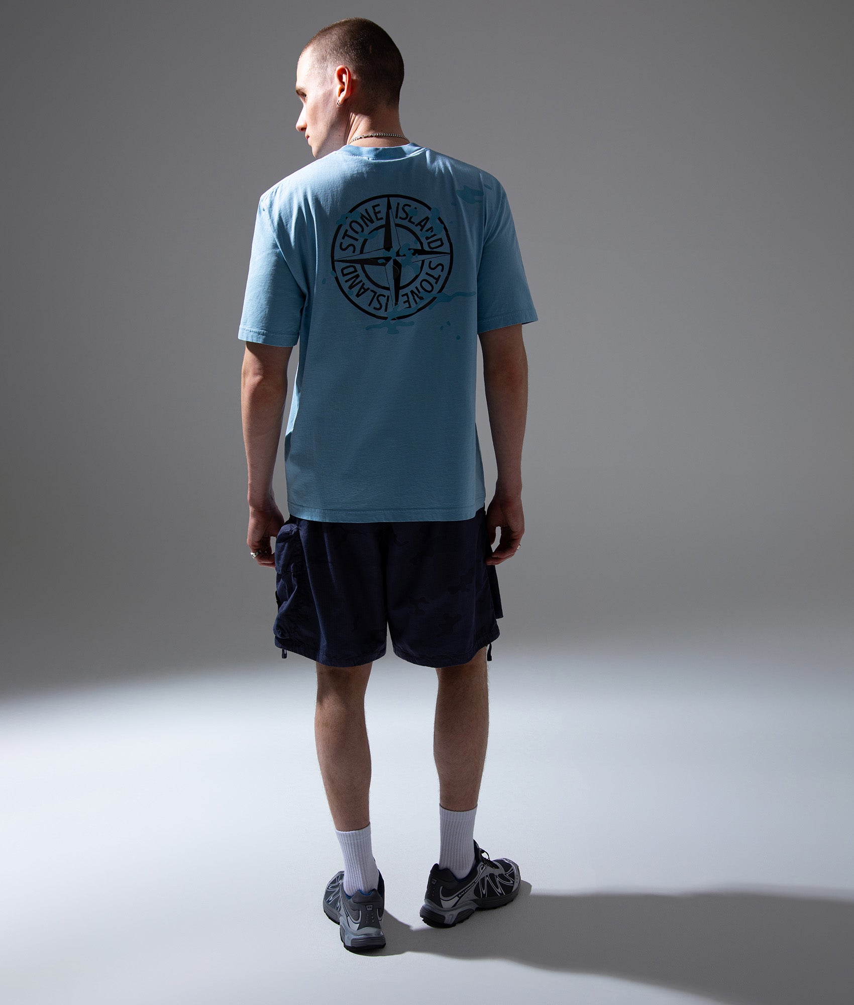 Stone Island ‘Camo Compass’ Print T-Shirt in Powder Blue at EQVVS Menswear. Campaign shot.