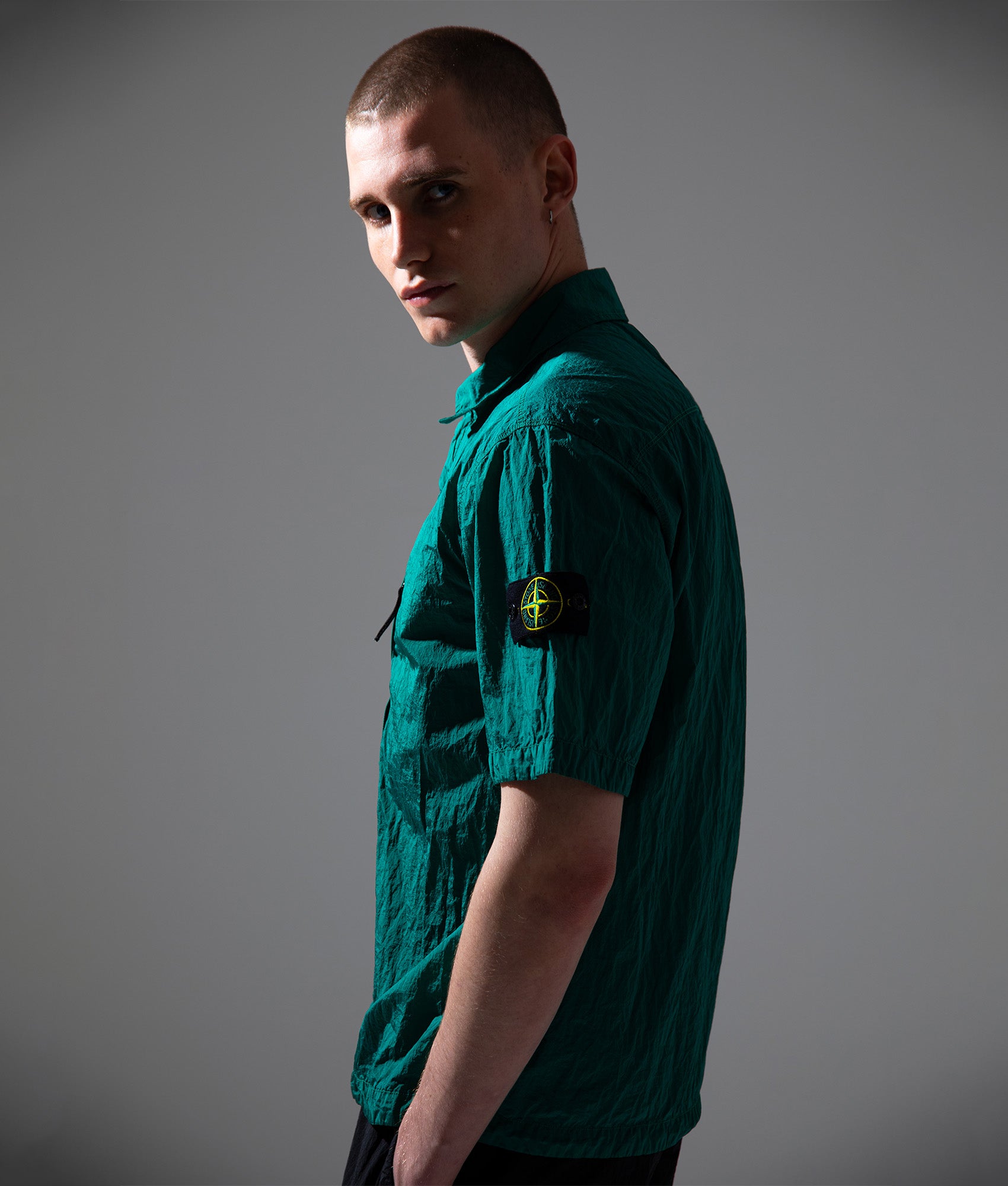 Stone Island Comfort Fit Nylon Metal in ECONYL® Short Sleeve Shirt in V005H Malachite at EQVVS Menswear. Campaign shot.