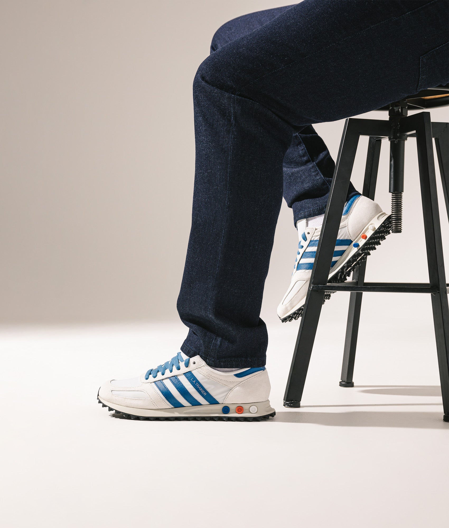 Adidas Originals LA Trainers in Off White, Dark Marine and Crystal White at EQVVS Menswear. Campaign shot.