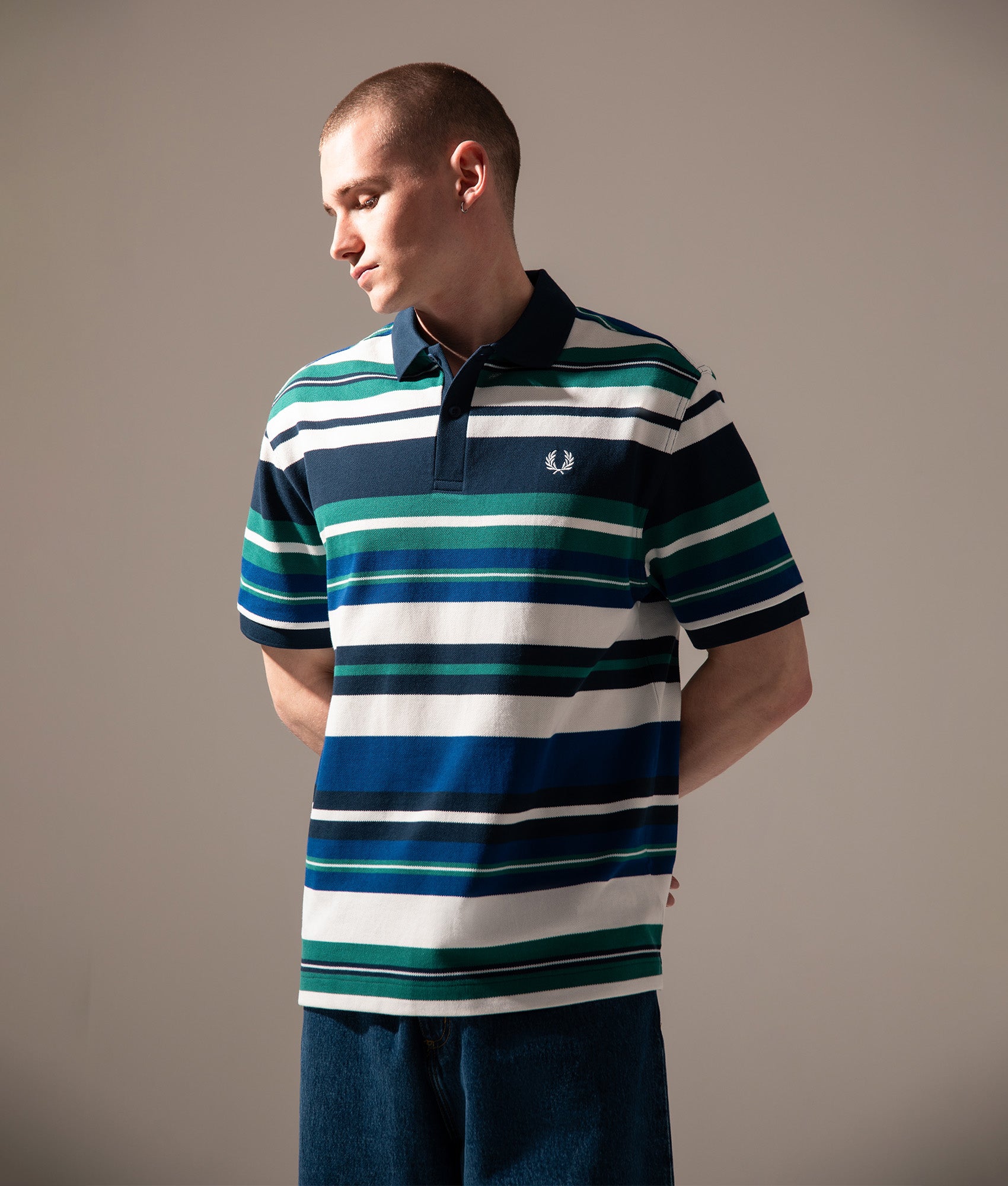 Fred Perry Relaxed Fit Striped Polo Shirt   in Deep Mint at EQVVS Menswear. Campaign shot.