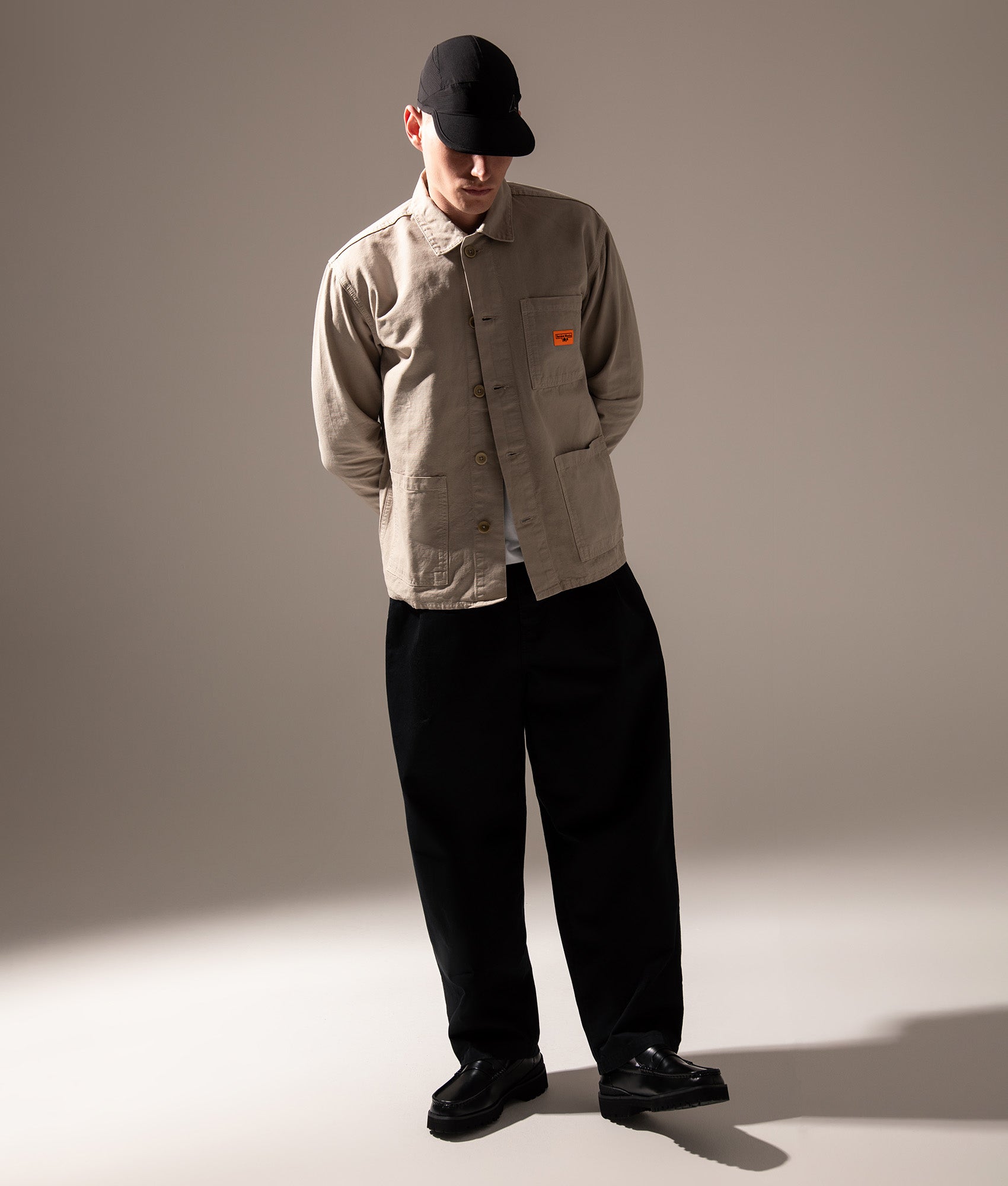 Service Works Canvas Chore Shirt in Stone at EQVVS Menswear. Campaign shot.