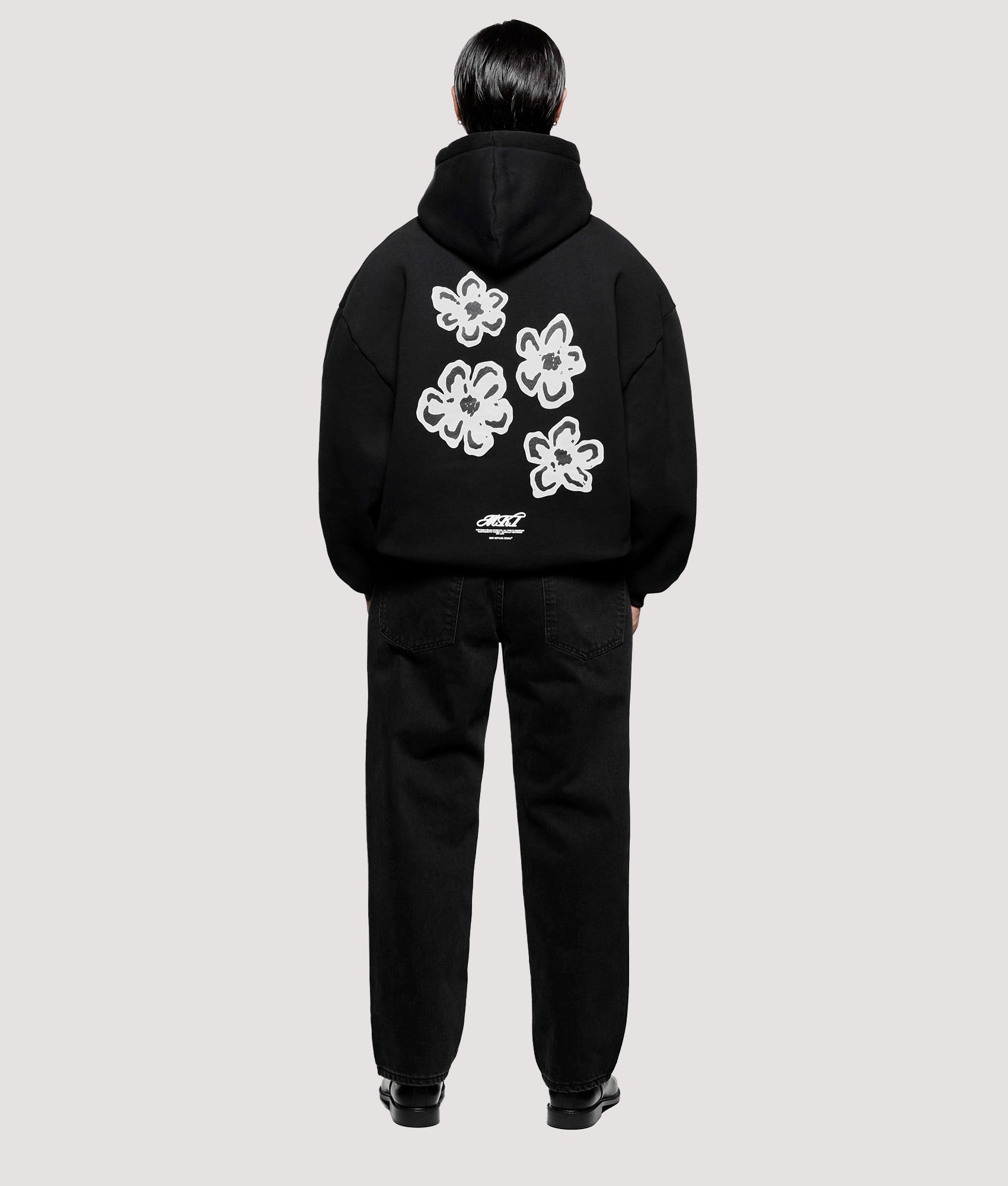MKI MIYUKI ZOKU Box Fit Hibiscus Hoodie in Black at EQVVS Menswear.  Model full back shot.