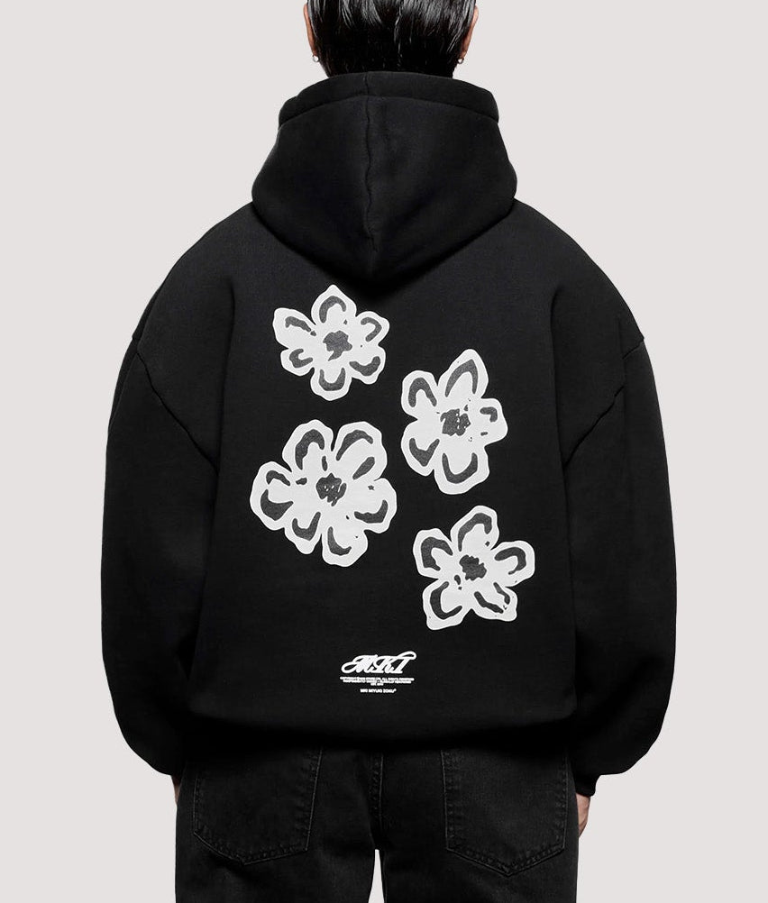 MKI MIYUKI ZOKU Box Fit Hibiscus Hoodie in Black at EQVVS Menswear.  Model full back shot.