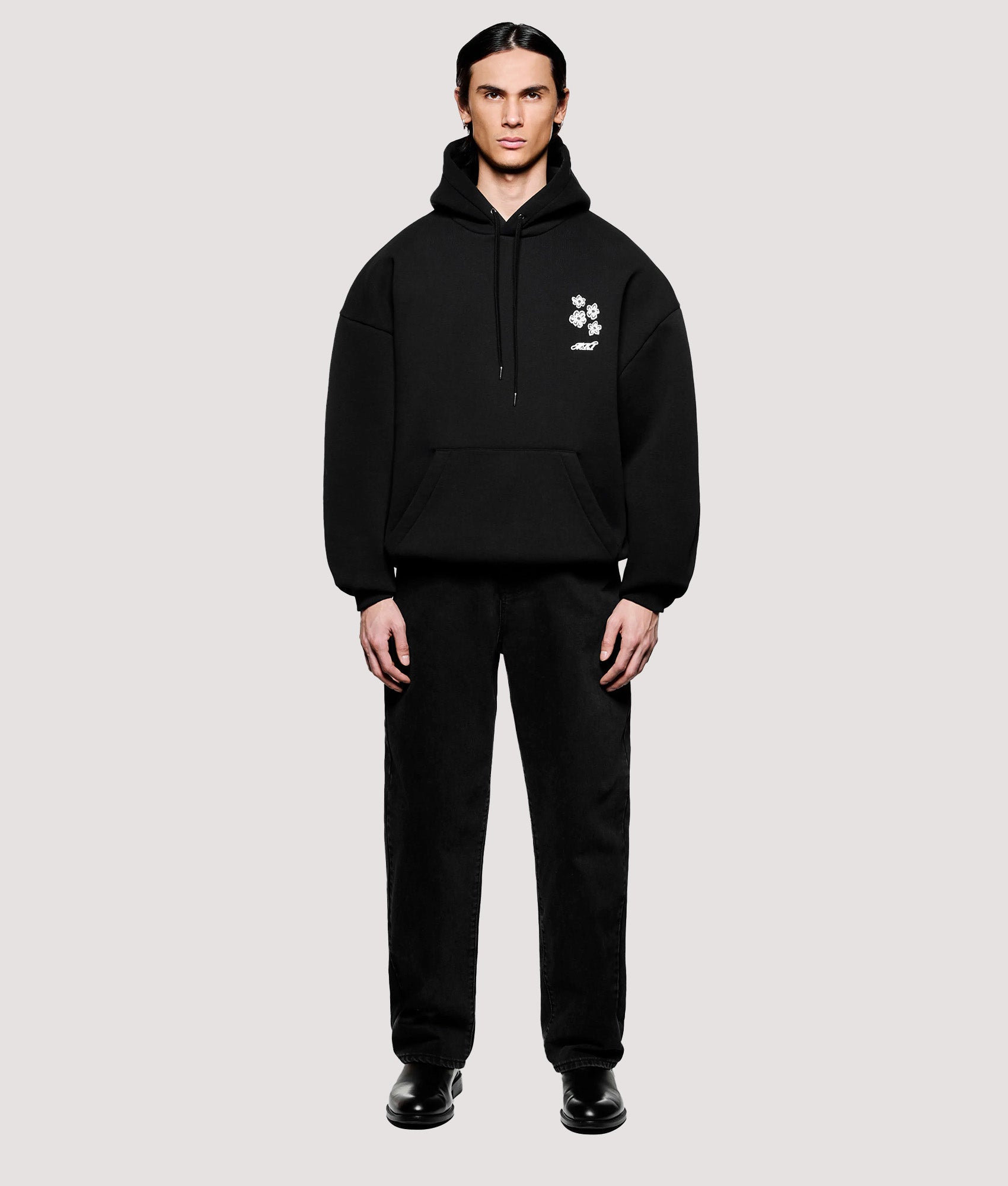 MKI MIYUKI ZOKU Box Fit Hibiscus Hoodie in Black at EQVVS Menswear. Model full front shot.