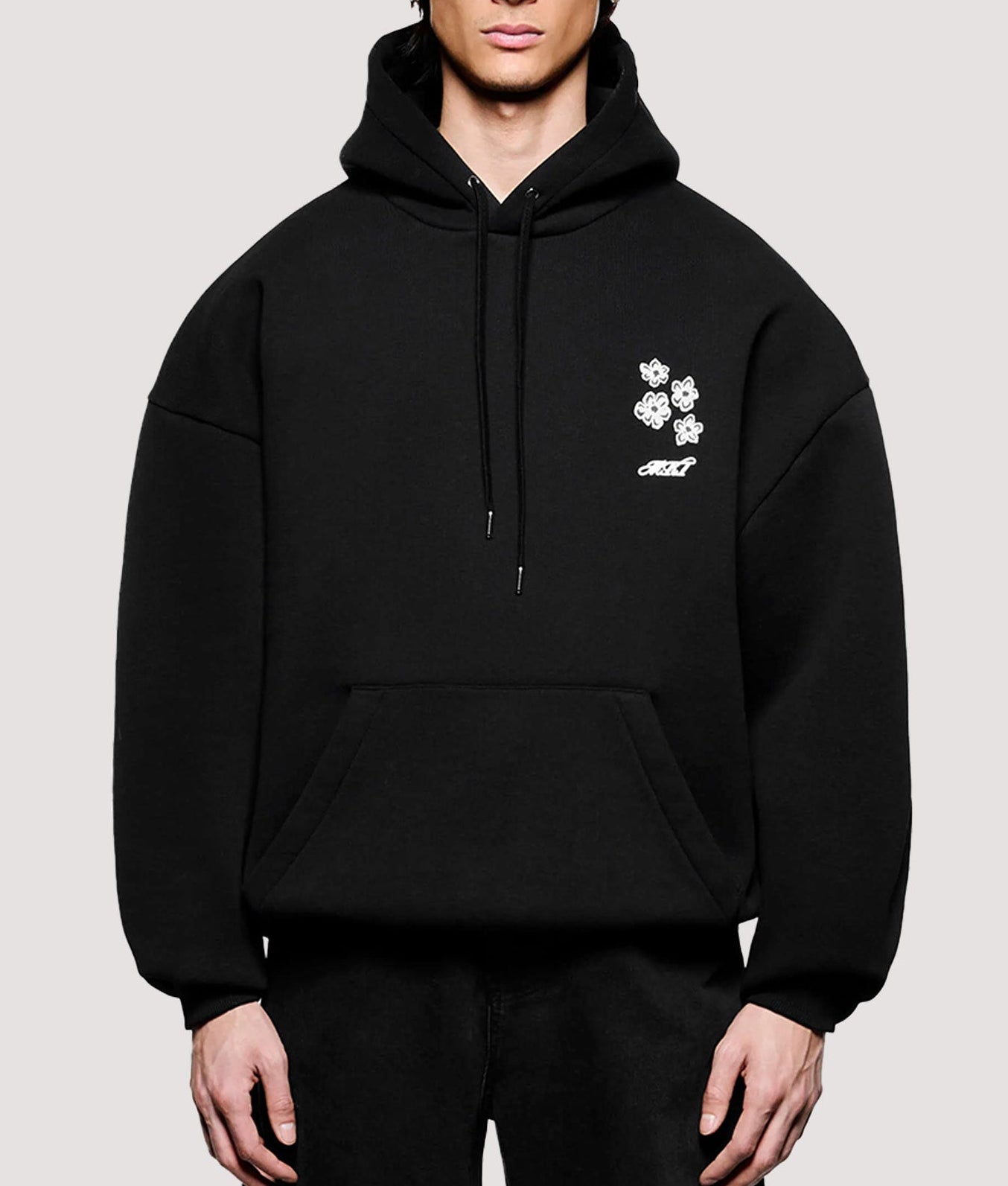MKI MIYUKI ZOKU Box Fit Hibiscus Hoodie in Black at EQVVS Menswear. Model front shot.