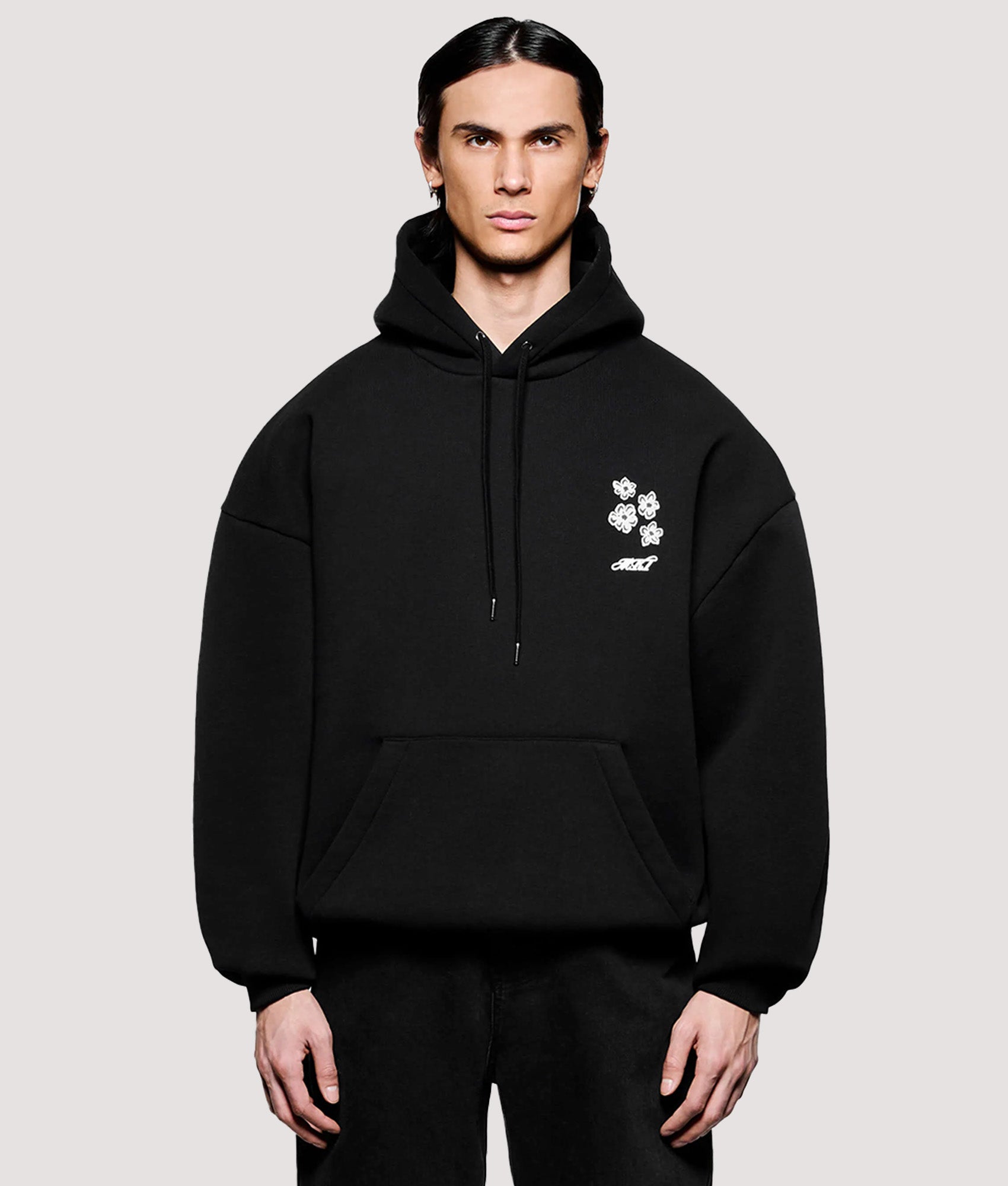 MKI MIYUKI ZOKU Box Fit Hibiscus Hoodie in Black at EQVVS Menswear. Model front shot.