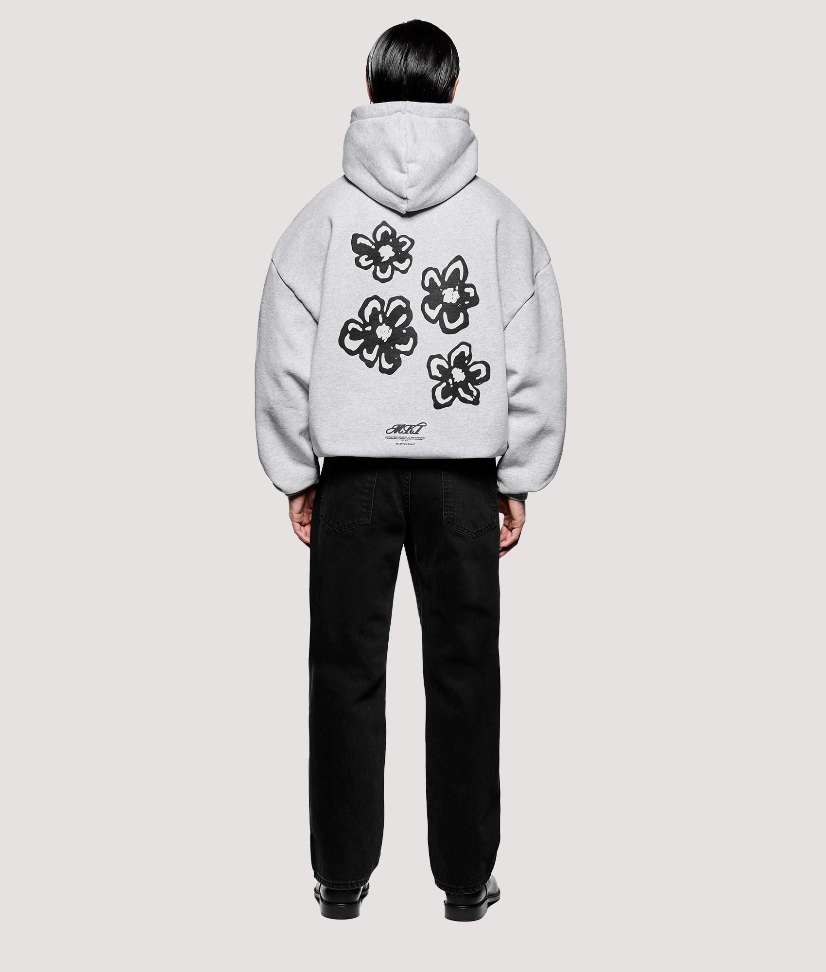 MKI MIYUKI ZOKU Box Fit Hibiscus Hoodie in Grey at EQVVS Menswear. Model full back shot.