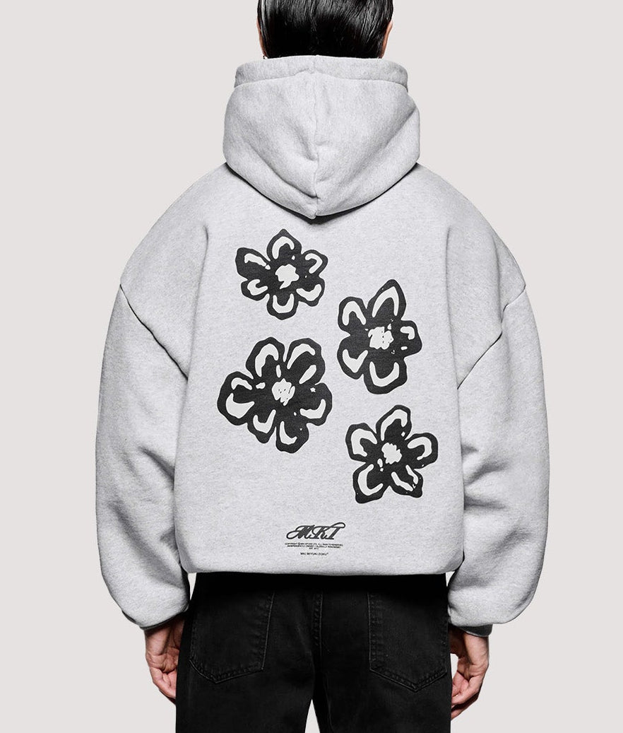 MKI MIYUKI ZOKU Box Fit Hibiscus Hoodie in Grey at EQVVS Menswear. Model full back shot.