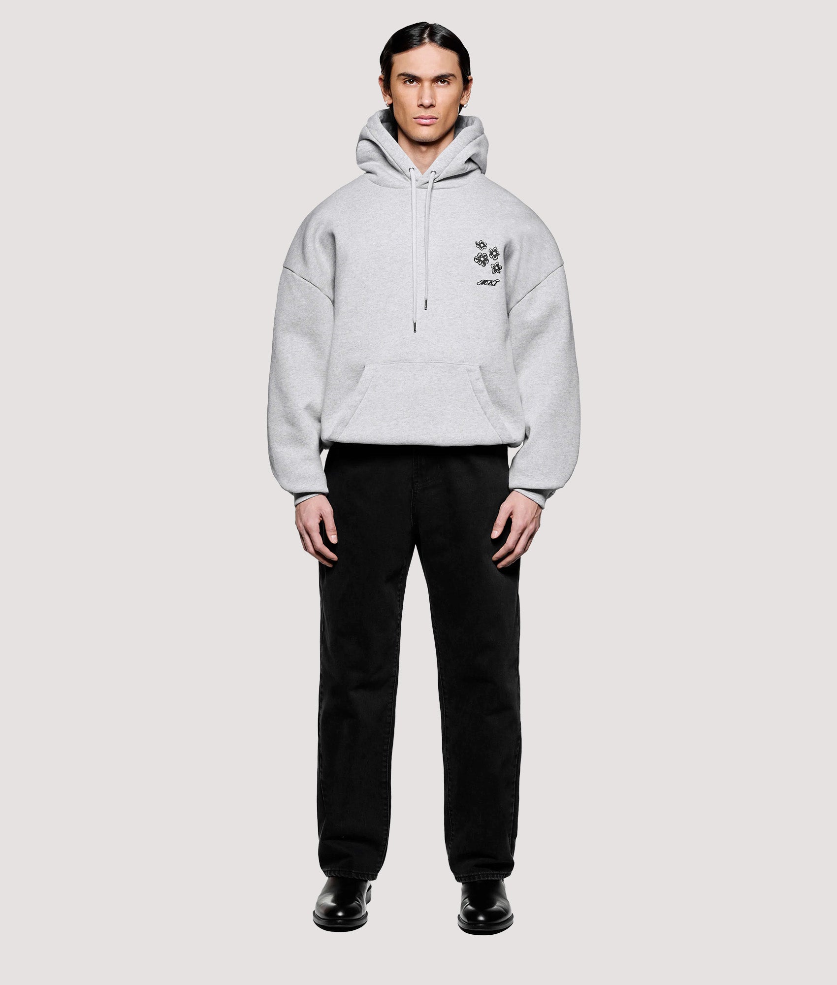MKI MIYUKI ZOKU Box Fit Hibiscus Hoodie in Grey at EQVVS Menswear. Model front shot.