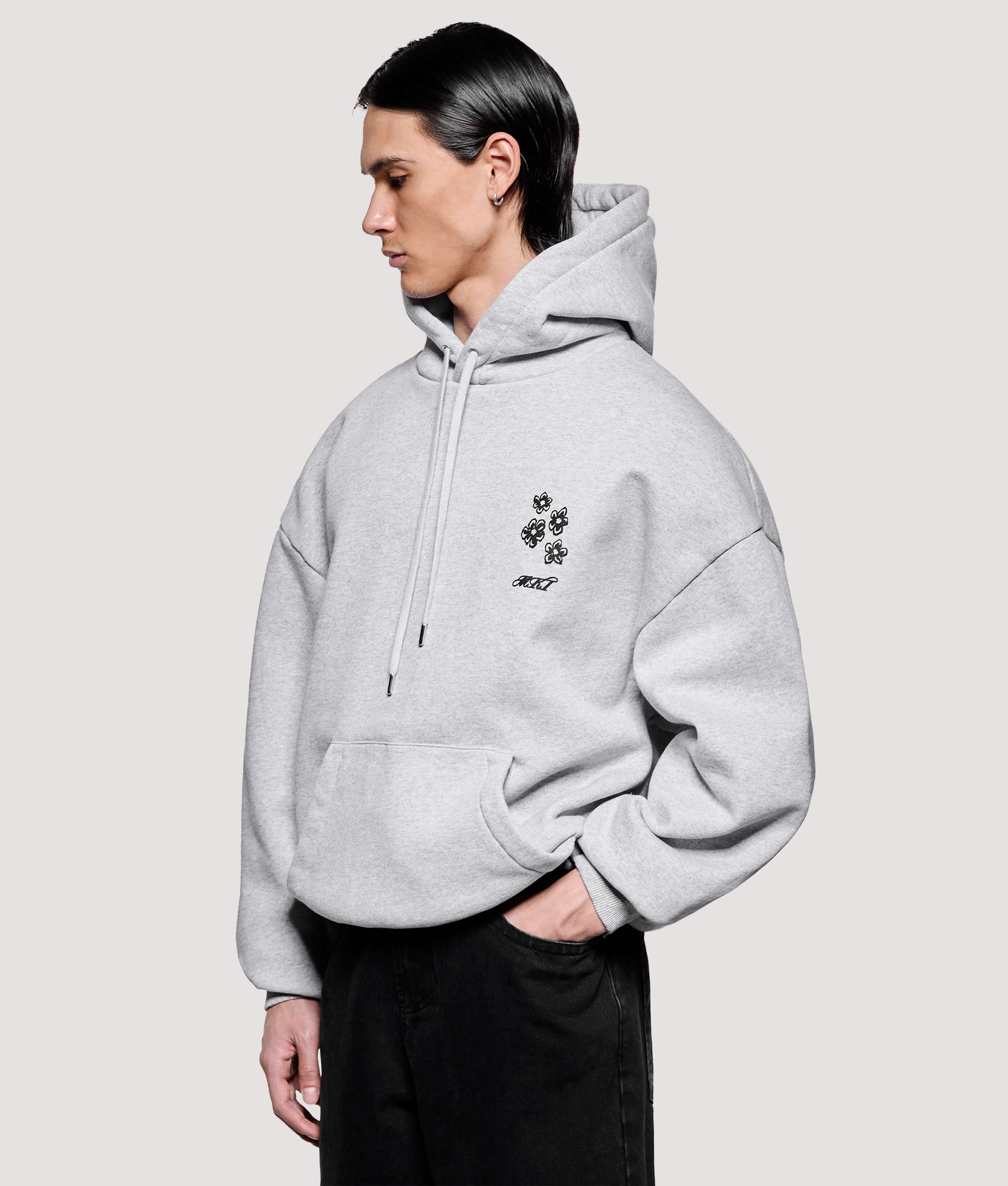 MKI MIYUKI ZOKU Box Fit Hibiscus Hoodie in Grey at EQVVS Menswear. Model front shot.