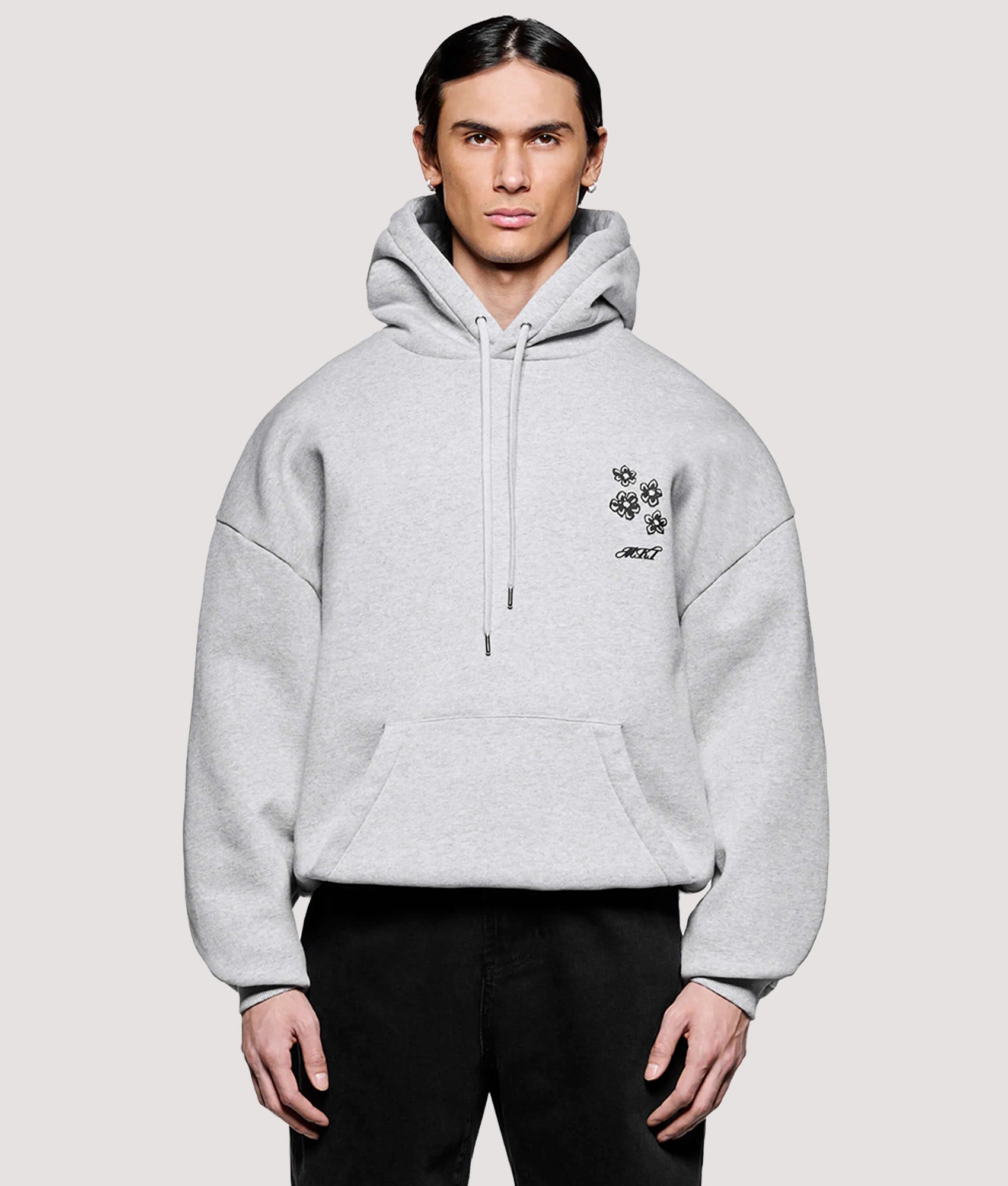 MKI MIYUKI ZOKU Box Fit Hibiscus Hoodie in Grey at EQVVS Menswear. Model front shot.
