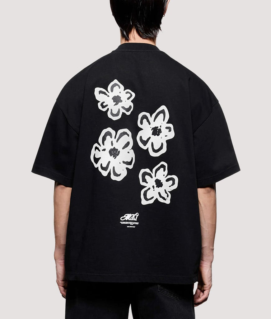 MKI MIYUKI ZOKU Box Fit Hibiscus T-Shirt in Black at EQVVS Menswear. Model full back shot.