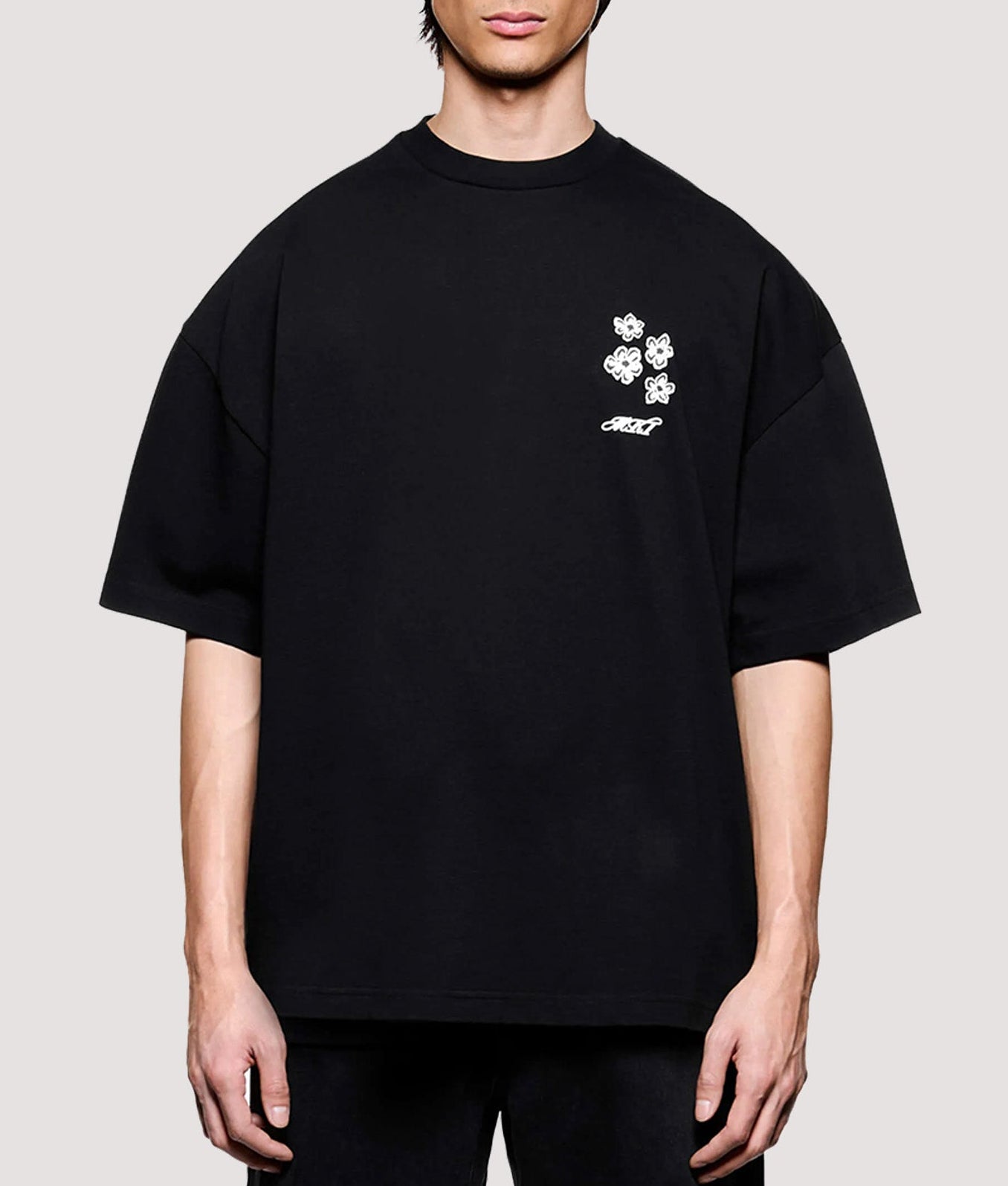 MKI MIYUKI ZOKU Box Fit Hibiscus T-Shirt in Black at EQVVS Menswear. Model front shot.