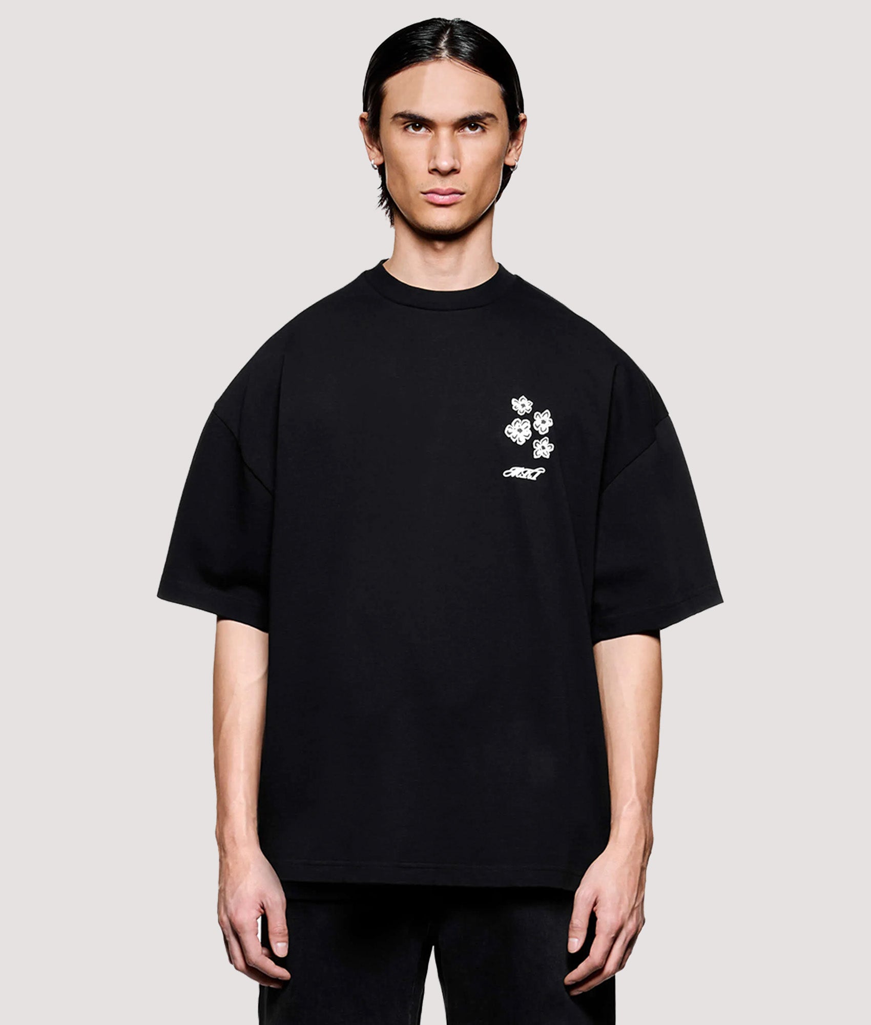 MKI MIYUKI ZOKU Box Fit Hibiscus T-Shirt in Black at EQVVS Menswear. Model front shot.