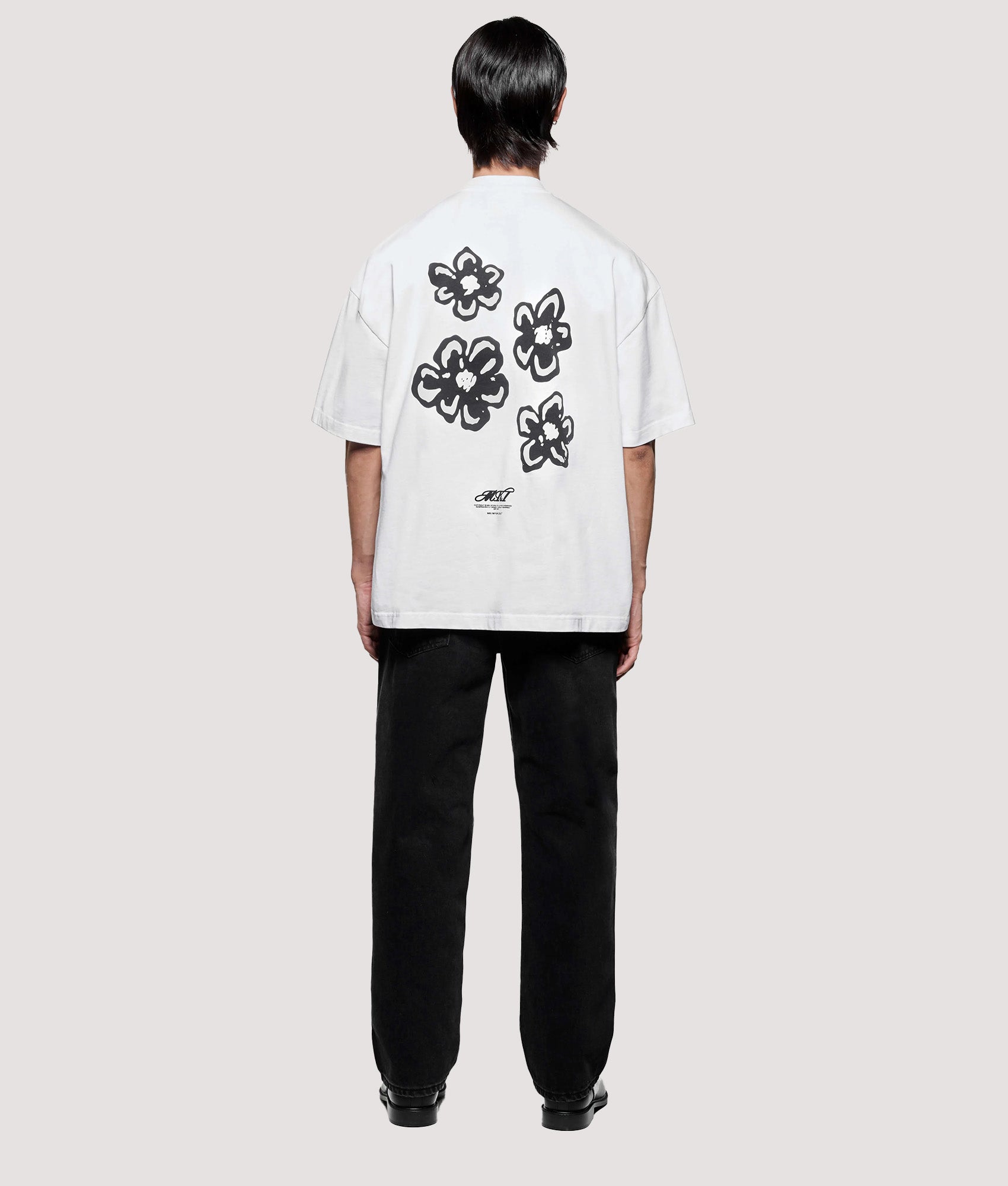 MKI MIYUKI ZOKU Box Fit Hibiscus T-Shirt in White at EQVVS Menswear. Model full back shot.