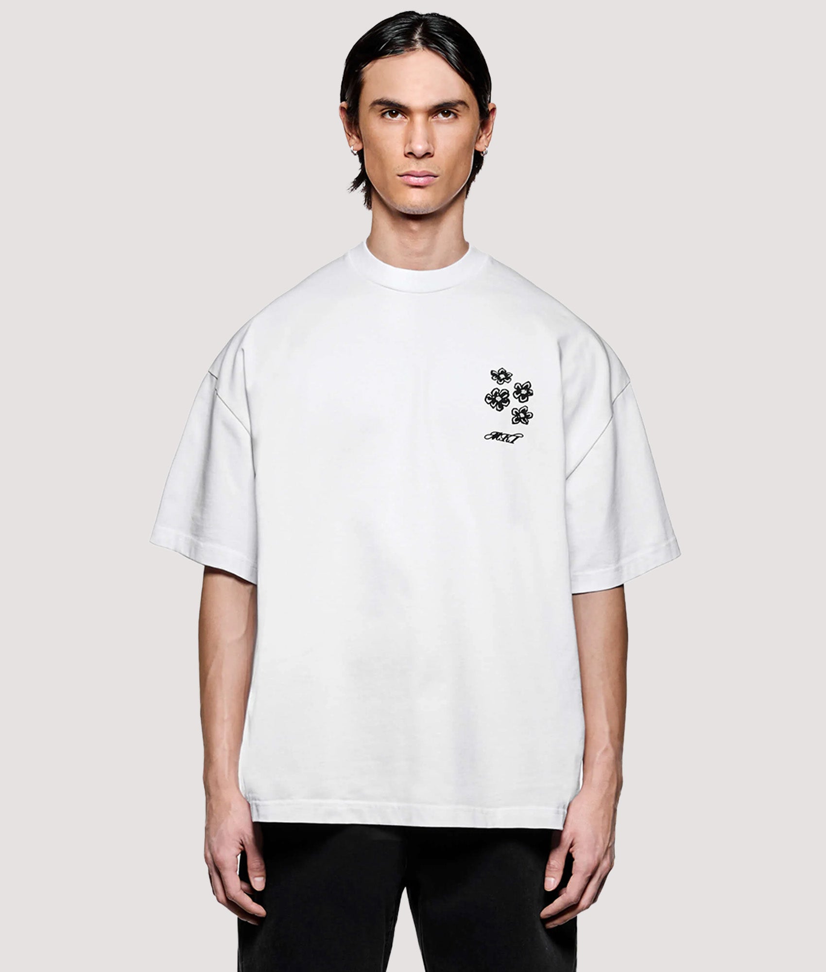 MKI MIYUKI ZOKU Box Fit Hibiscus T-Shirt in White at EQVVS Menswear. Model front shot.
