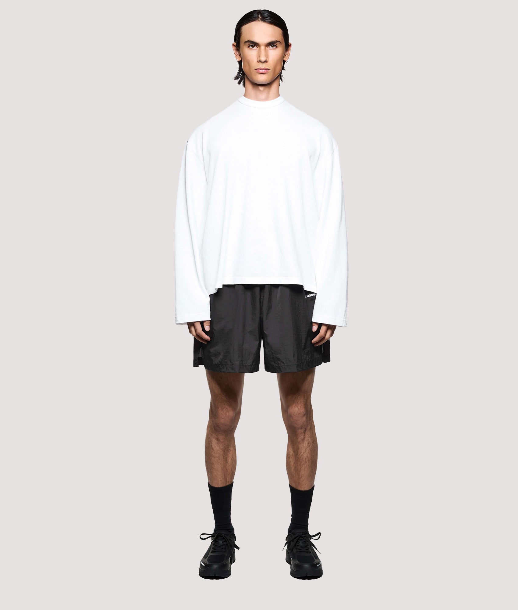 MKI MIYUKI ZOKU Relaxed Fit Hyperlight Wind Shorts in Black at EQVVS Menswear. Full model front shot.
