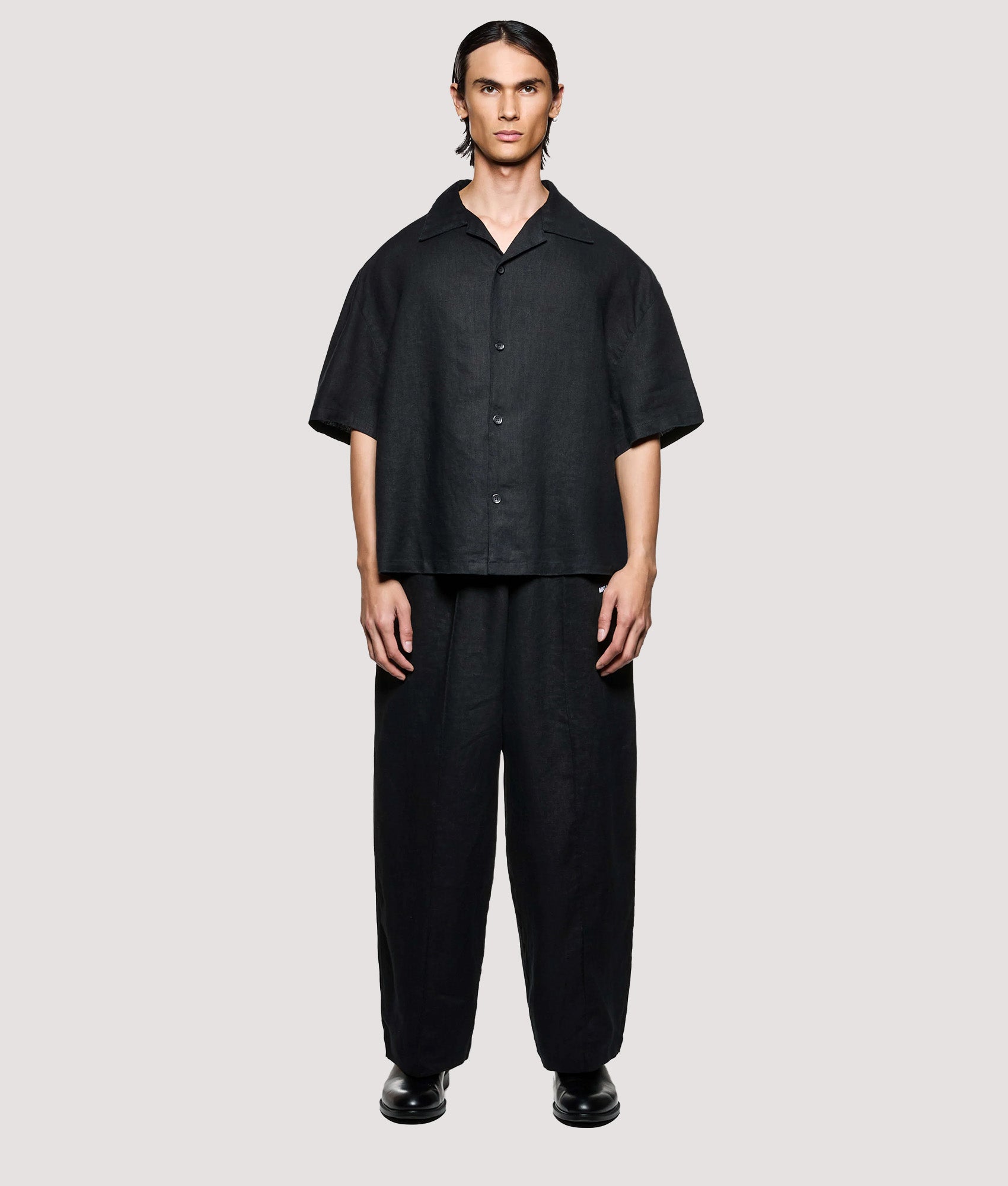 MKI MIYUKI ZOKU Box Fit Linen Short Sleeve Vacation Shirt in Black at EQVVS Menswear. Model full front shot.