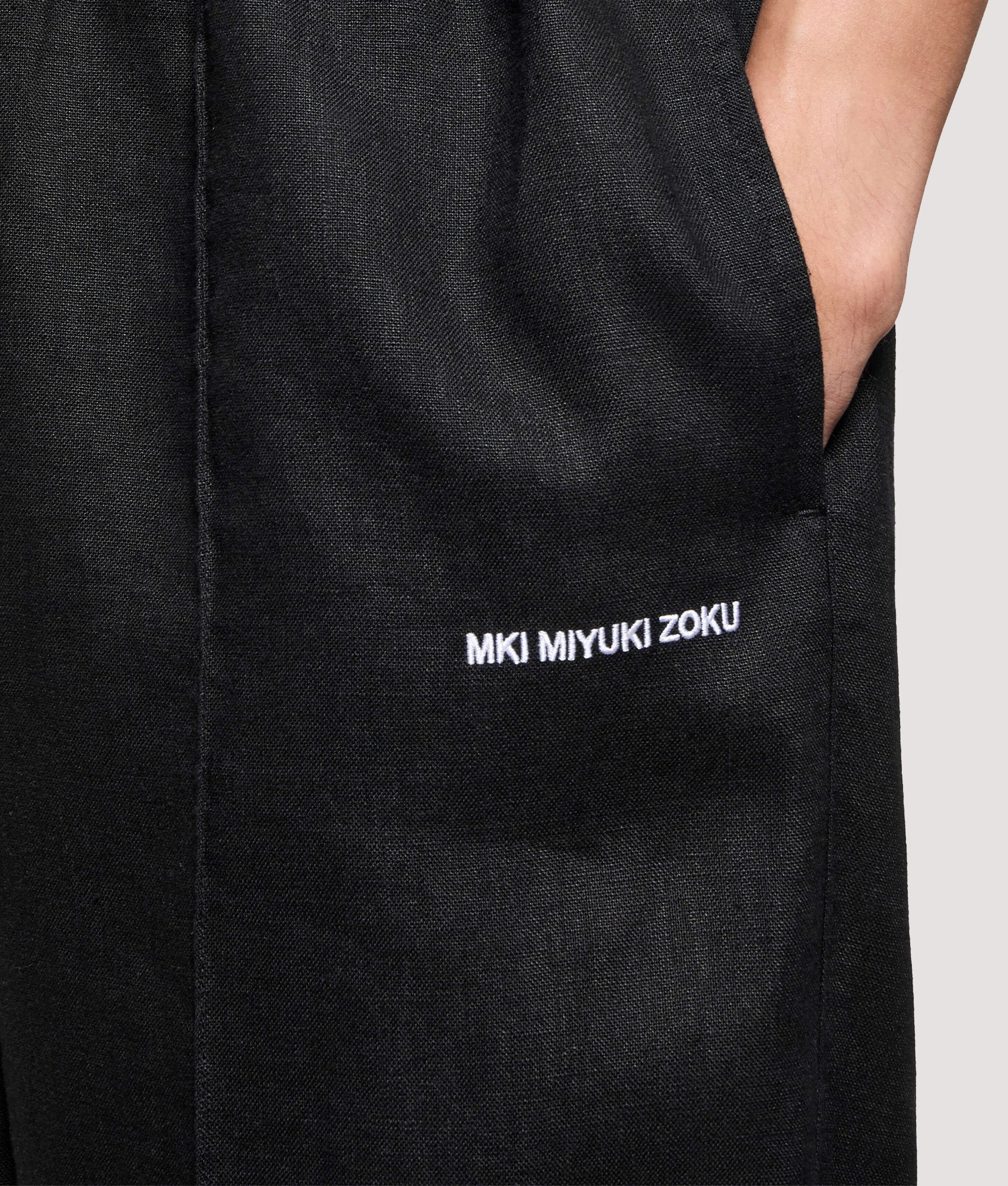 MKI MIYUKI ZOKU Relaxed Fit Linen Wide Leg Pants in Black at EQVVS Menswear. Detail shot.