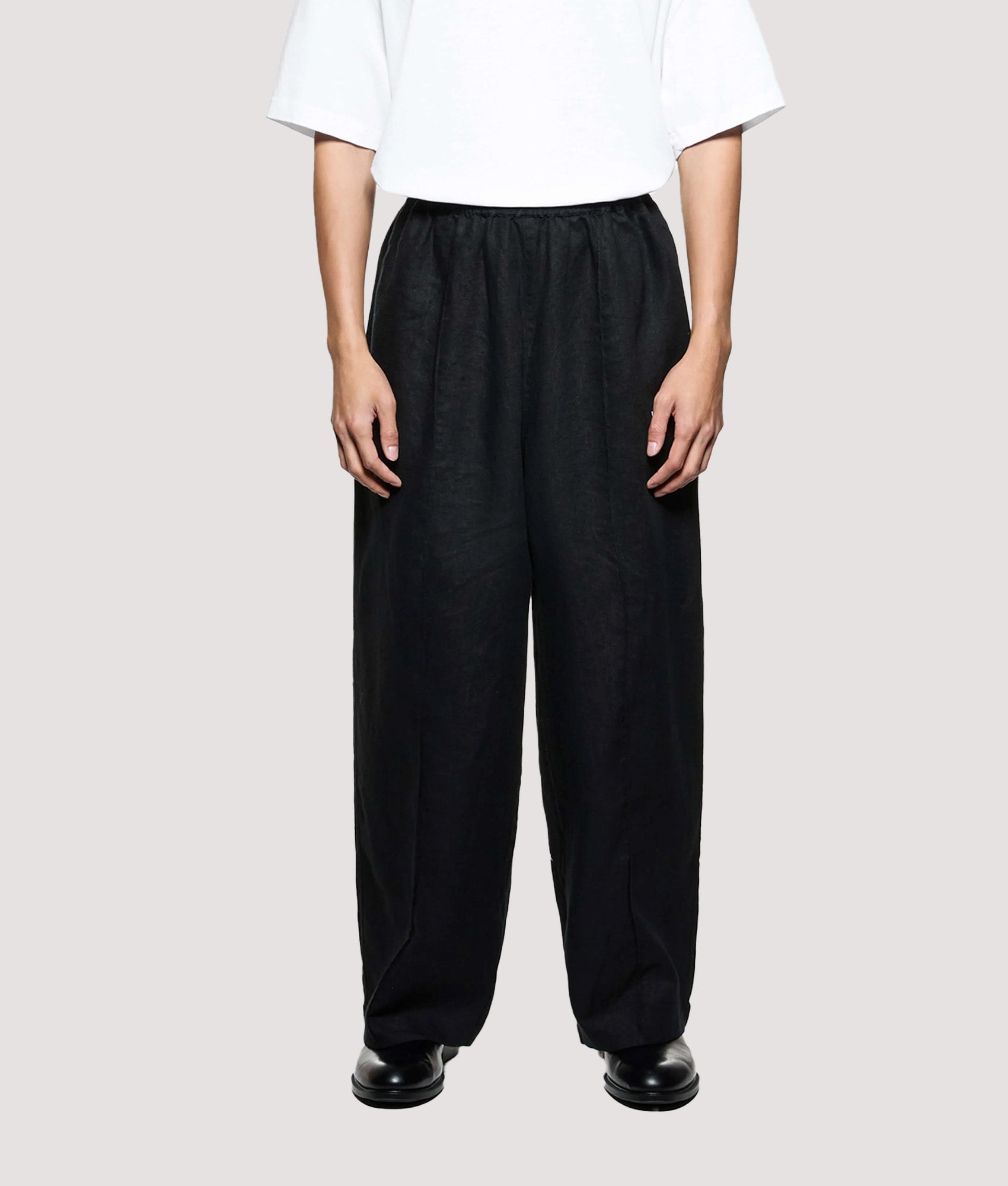 MKI MIYUKI ZOKU Relaxed Fit Linen Wide Leg Pants in Black at EQVVS Menswear. Model front shot.