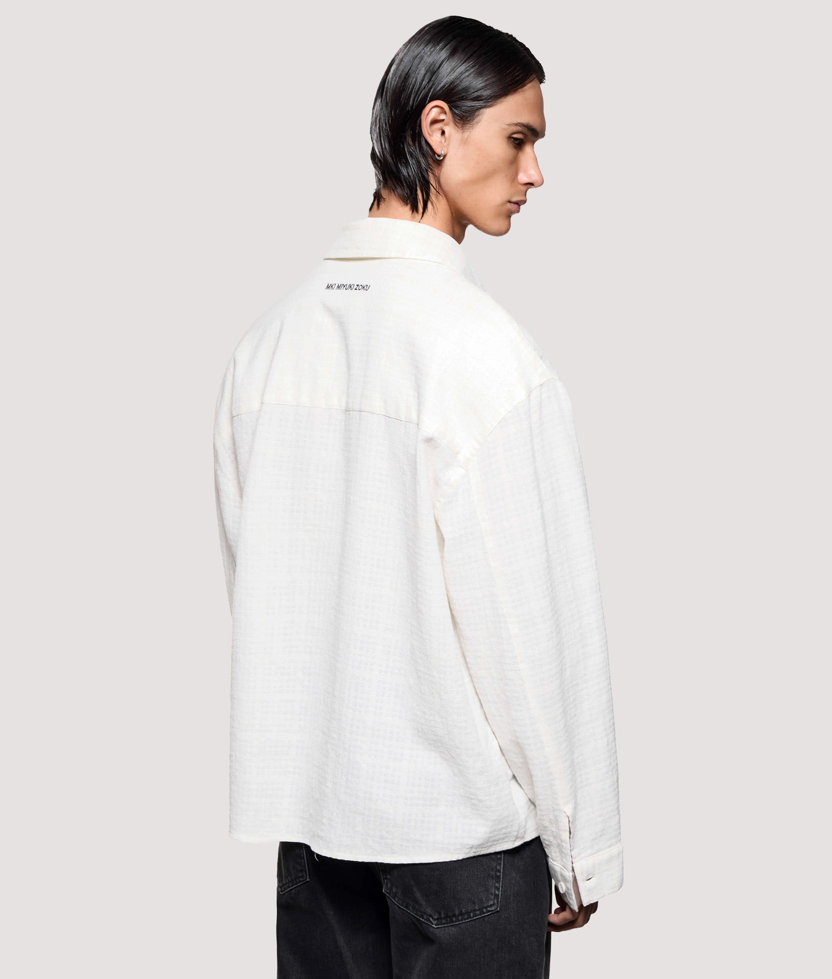 MKI MIYUKI ZOKU Box Fit Loose Weave Check Dress Shirt in Bone at EQVVS Menswear. Angled model back shot.