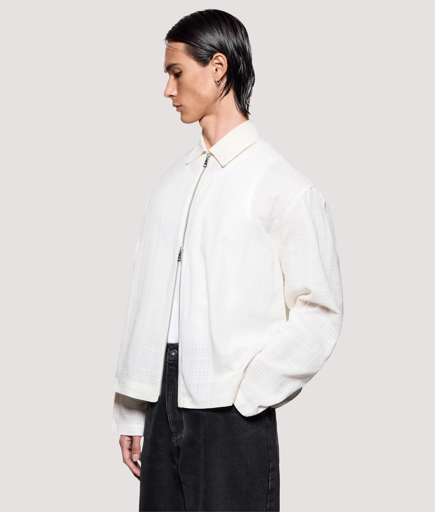 MKI MIYUKI ZOKU Box Fit Loose Weave Check Rider in Bone at EQVVS Menswear. Angled model front shot.